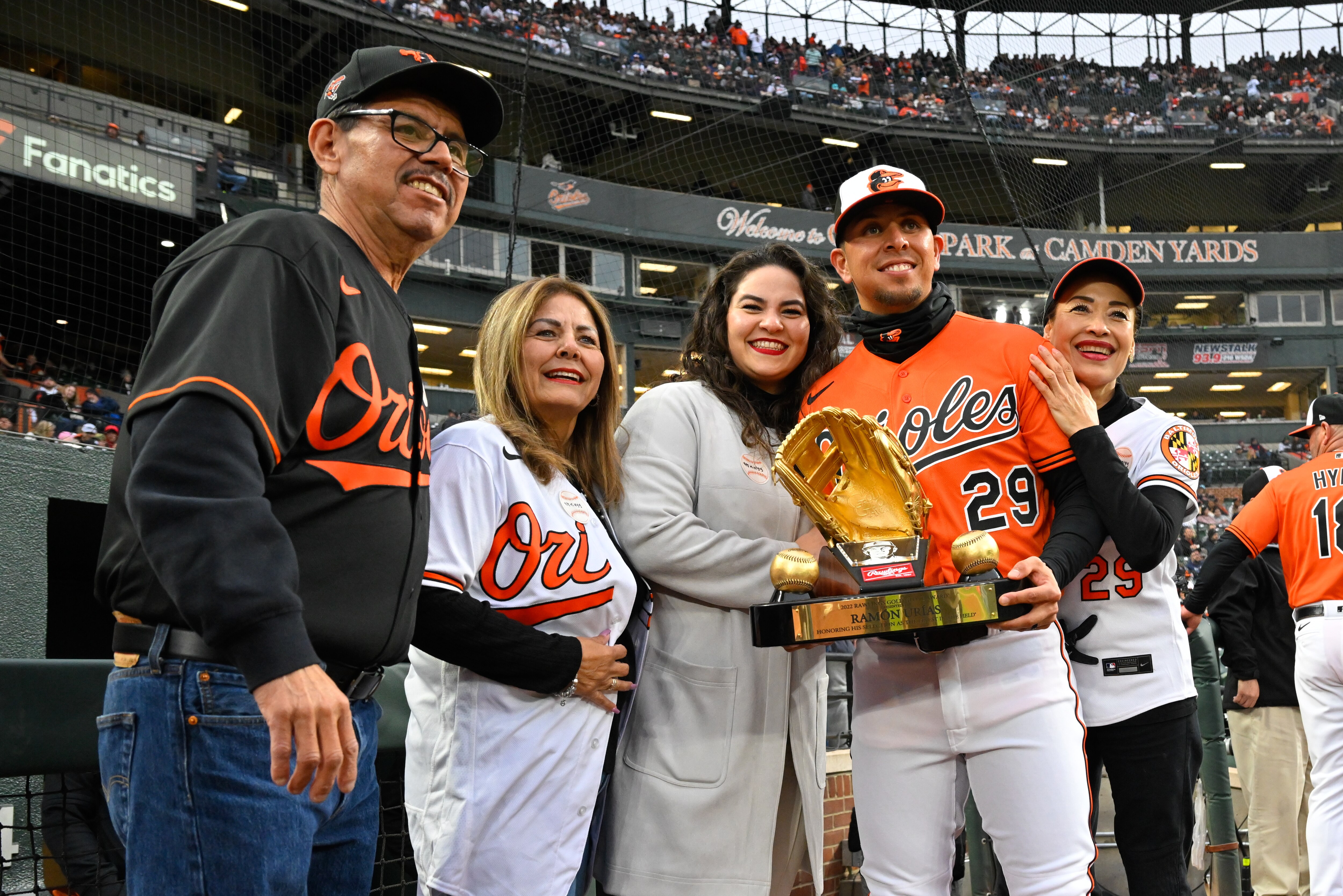 Orioles third baseman Ramón Urías poses with his family after receiving his 2022 Gold Glove award before a home game in April. Urías' parents got to see him play again Saturday in Arizona.