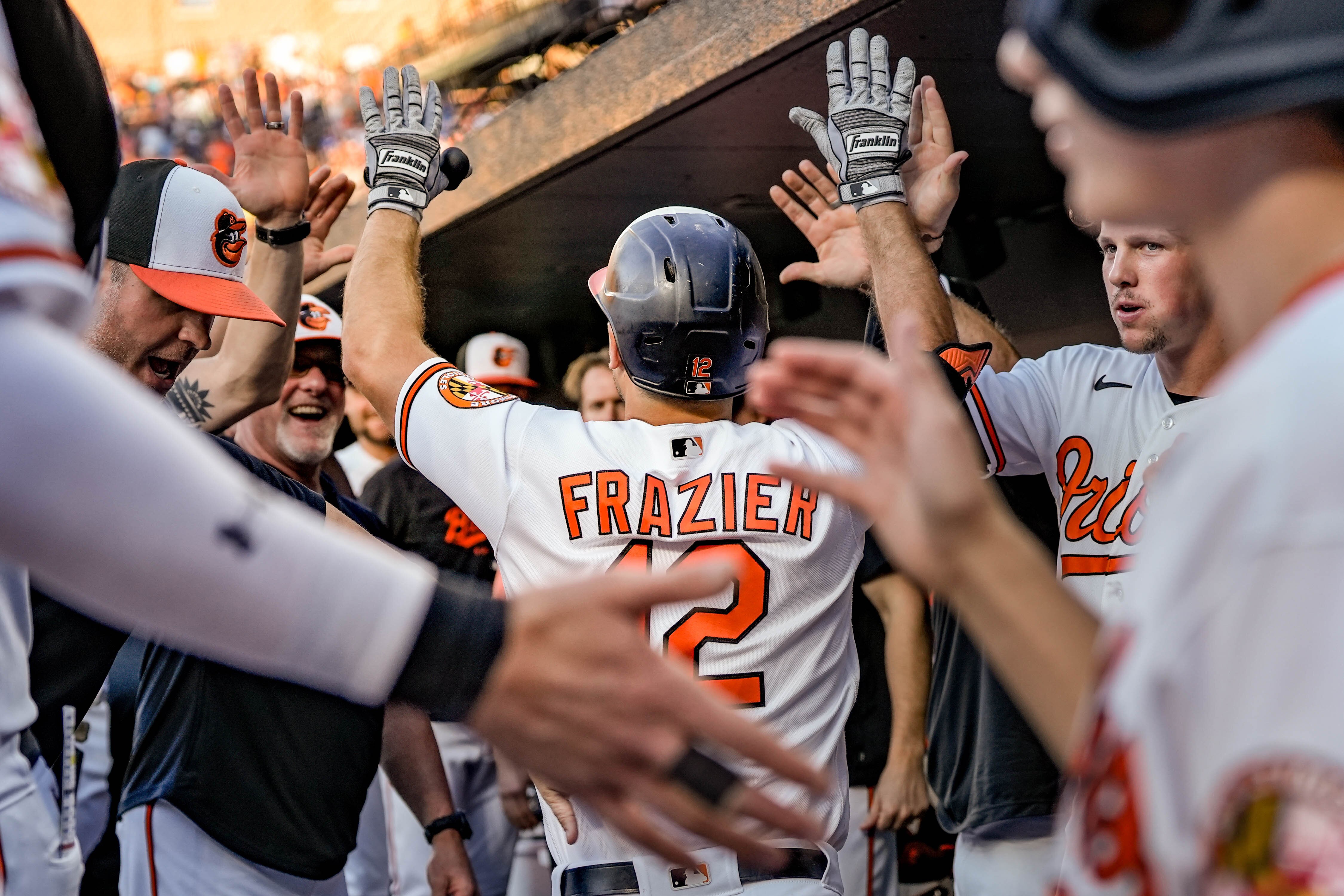 Orioles left fielder Adam Frazier receives congratulations after his three-run first-inning home run as the team clinched its season series against the Yankees.