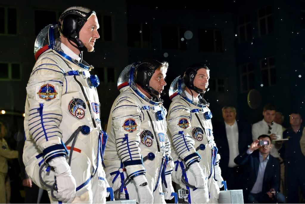 European Space Agency's astronaut Alexander Gerst, left, Russian cosmonaut Maxim Suraev, center, and NASA astronaut Reid Wiseman, crew members of the mission to the International Space Station, ISS, report to members of the State Committee prior the launch of Soyuz-FG rocket at the Russian leased Baikonur cosmodrome, Kazakhstan, Wednesday, May 28, 2014.
