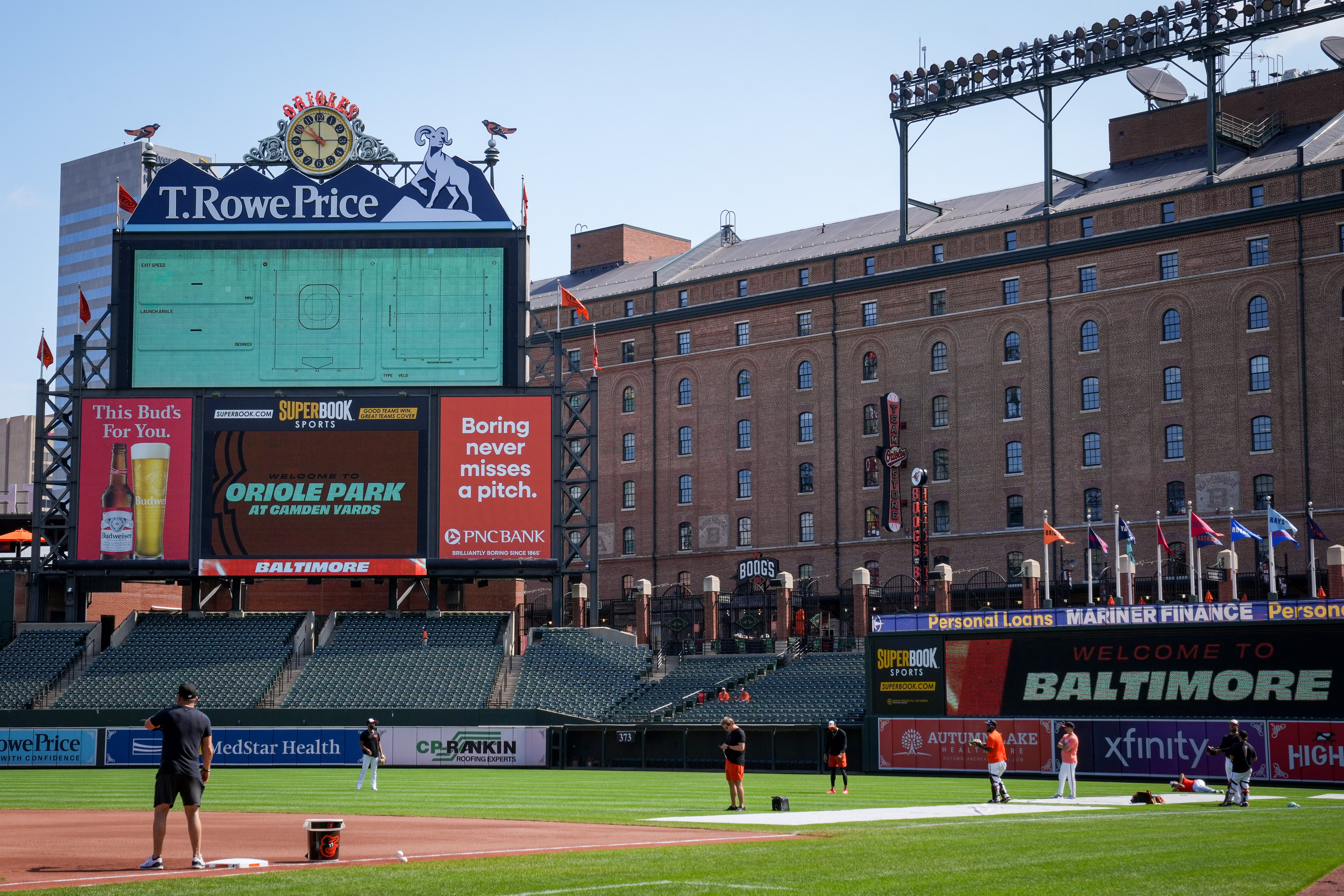 The T. Rowe Price sign on the Orioles scoreboard is seen while players warm up before a game last season.