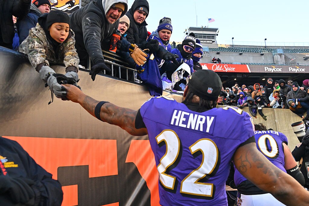 Ravens running back Derrick Henry high fives fans after the team's 24-0 win over the Cincinnati Bengals at Paycor Stadium.