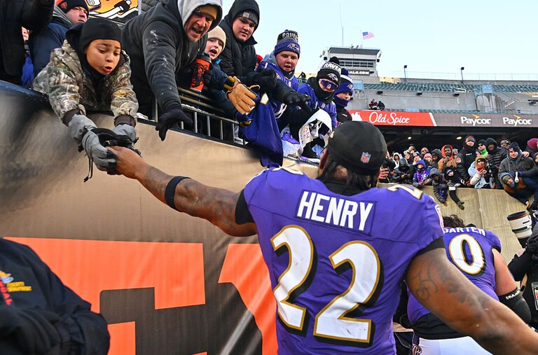 Ravens running back Derrick Henry high fives fans after the team's 24-0 win over the Cincinnati Bengals at Paycor Stadium.