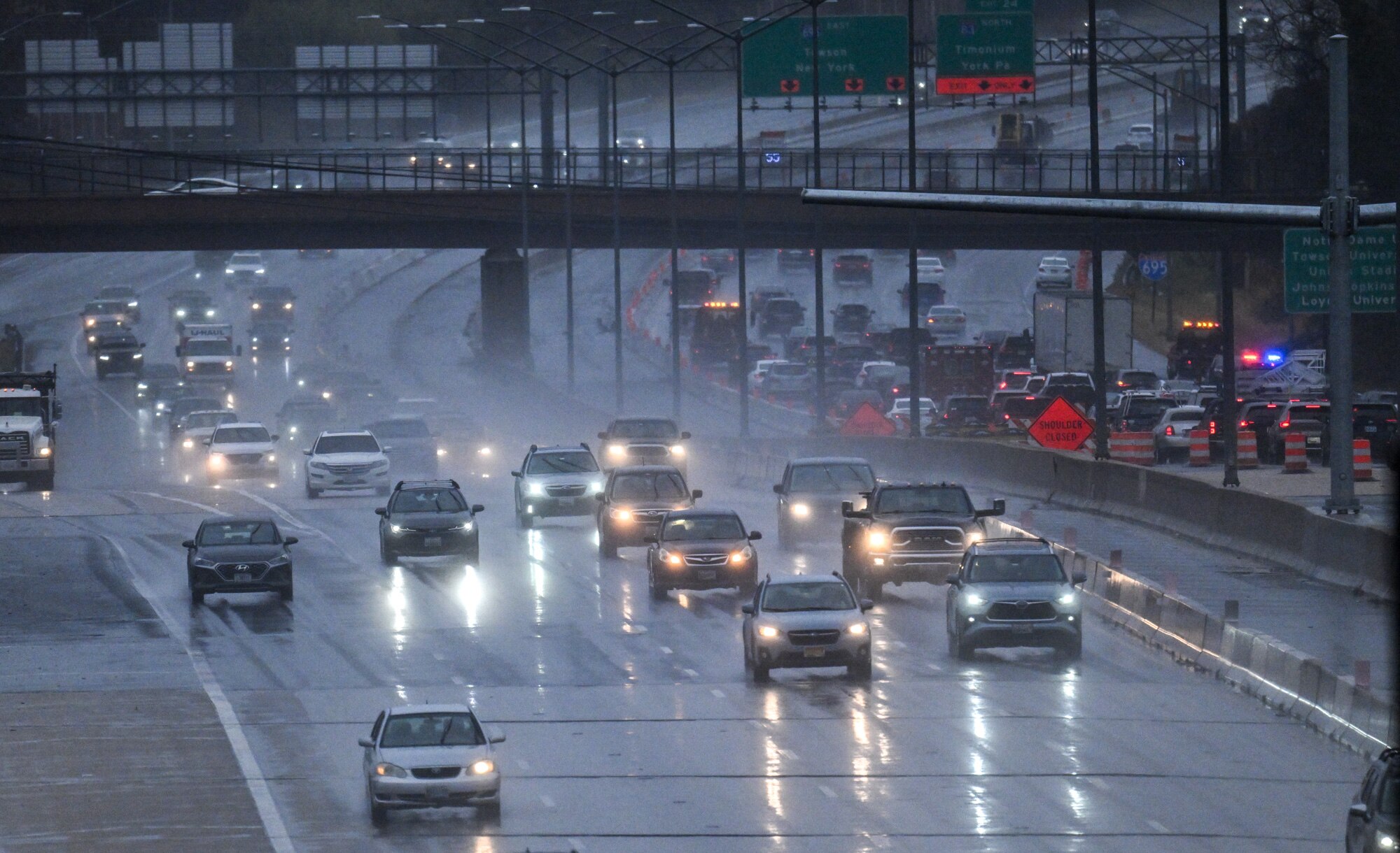 Traffic travels on the outer loop of I-695 at Falls Road as rain falls on the region. 