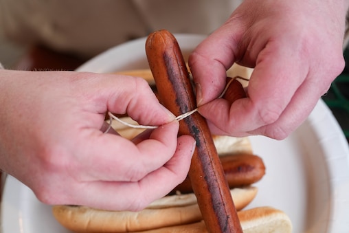 Baltimore Banner reporter Allan James Vestal measures the girth of hot dogs inside Oriole Park at Camden Yards in Baltimore, Md., on Monday, March 30, 2026.