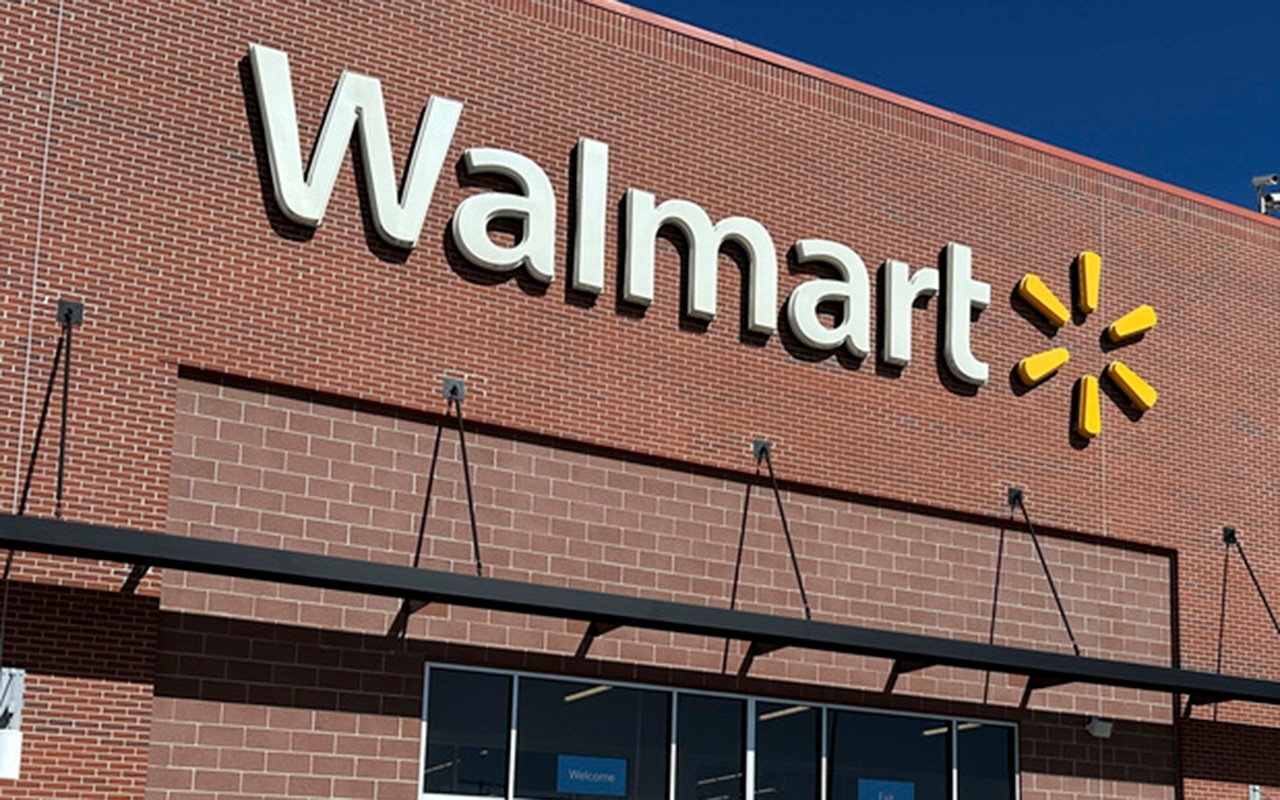 Shoppers head out of a Walmart store Wednesday, Feb. 21, 2024, in Englewood, Colo. (AP Photo/David Zalubowski)