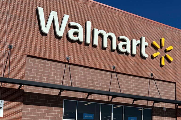 Shoppers head out of a Walmart store Wednesday, Feb. 21, 2024, in Englewood, Colo. (AP Photo/David Zalubowski)