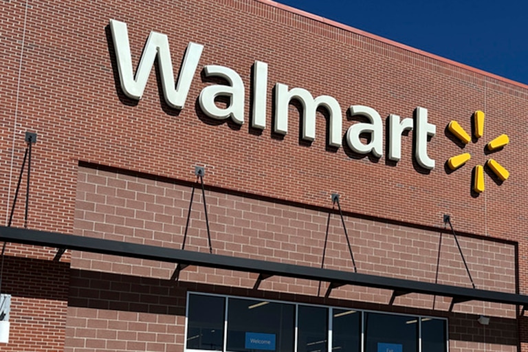 Shoppers head out of a Walmart store Wednesday, Feb. 21, 2024, in Englewood, Colo. (AP Photo/David Zalubowski)