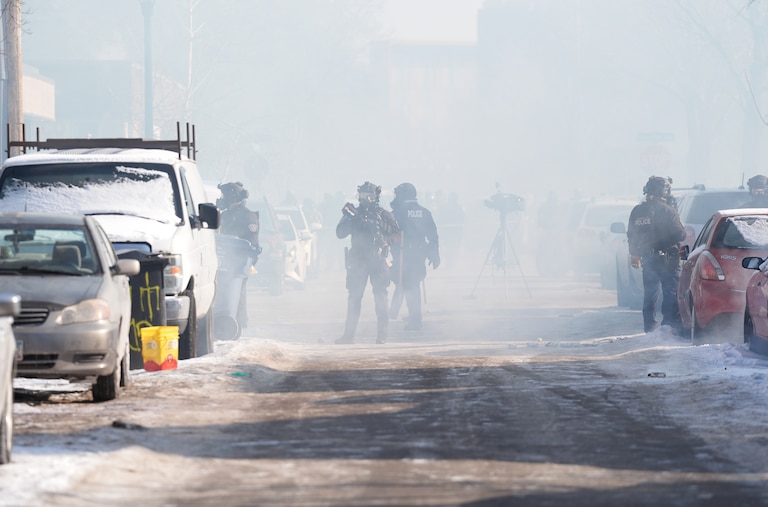 Federal immigration officers deploy tear gas at protesters after a shooting Saturday in Minneapolis.