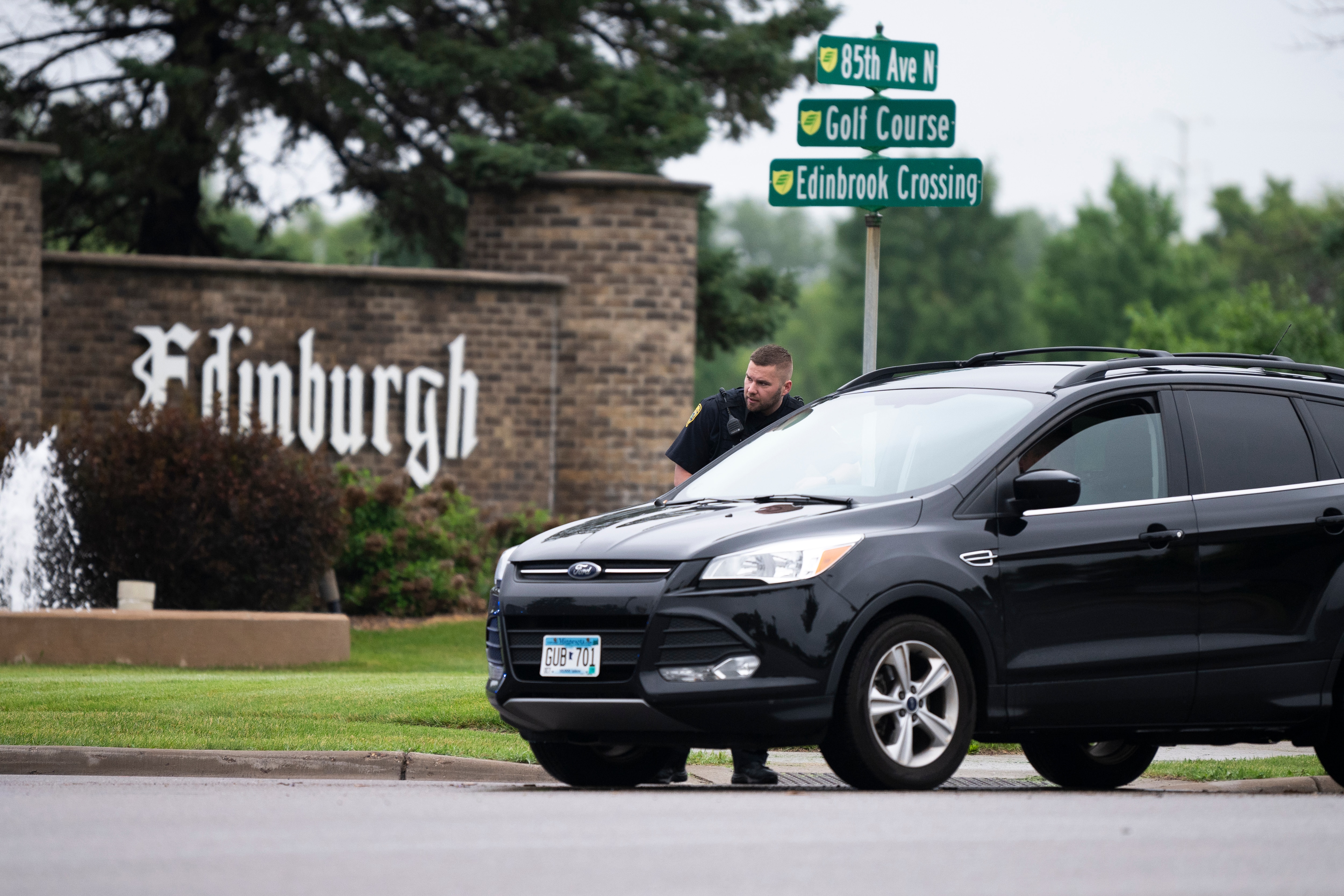BROOKLYN PARK, MINNESOTA - JUNE 14: A Brooklyn Park police officer speaks with the driver of a vehicle entering a neighborhood on June 14, 2025 in Brooklyn Park, Minnesota. Democratic-Farmer-Labor State Rep. Melissa Hortman and her husband were shot and killed this morning. Democratic-Farmer-Labor State Sen. John Hoffman and his wife were also shot and hospitalized in a separate incident. Minnesota Gov. Tim Walz said during a press conference that the shooting "appears to be a politically motivated assassination."