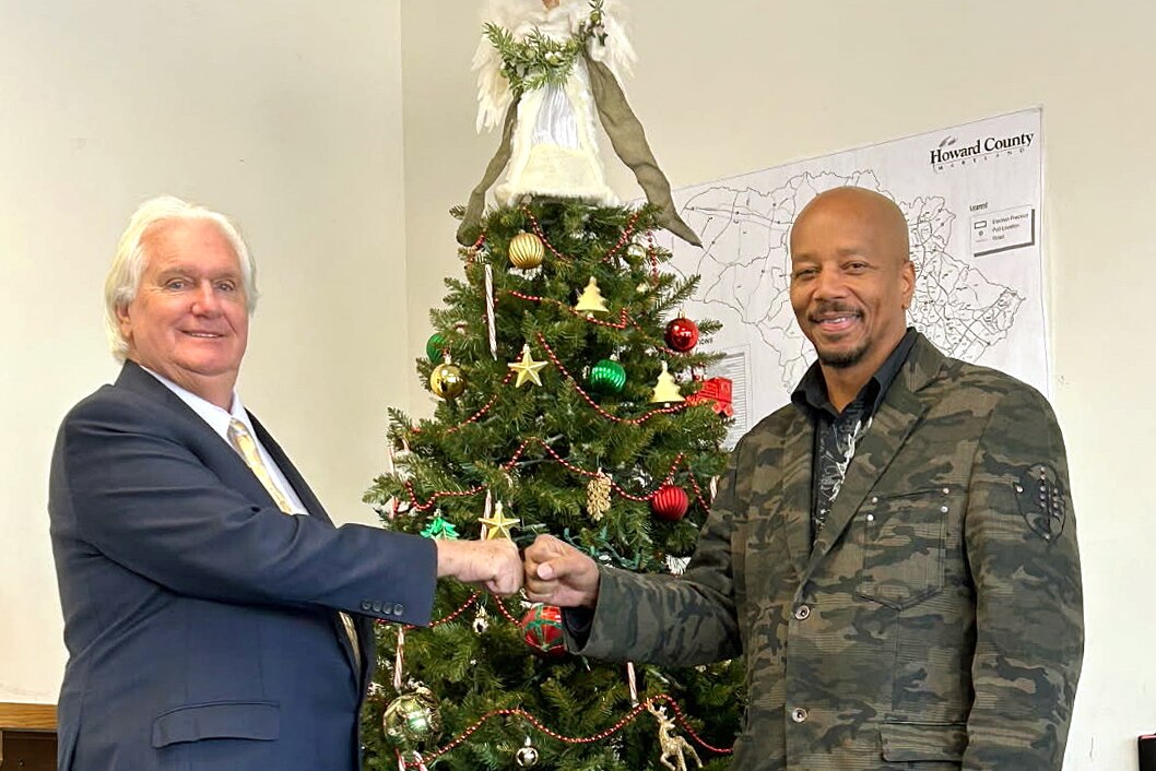 Howard County Executive candidate Bob Cockey, left, shakes hands with his campaign manager and local radio personality Konan The Ambassador, right.