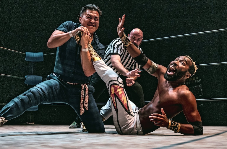 Filipinot Grigio, left, tries to submit “The World Famous” Cheeseburger at Flying V Theatre's "Double Dash II" on May 31, 2025. The two will appear at the nonprofit's "Fighter Fantasy" on Dec. 20 at Silver Spring Black Box Theatre.