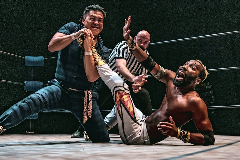 Filipinot Grigio, left, tries to submit “The World Famous” Cheeseburger at Flying V Theatre's "Double Dash II" on May 31, 2025. The two will appear at the nonprofit's "Fighter Fantasy" on Dec. 20 at Silver Spring Black Box Theatre.