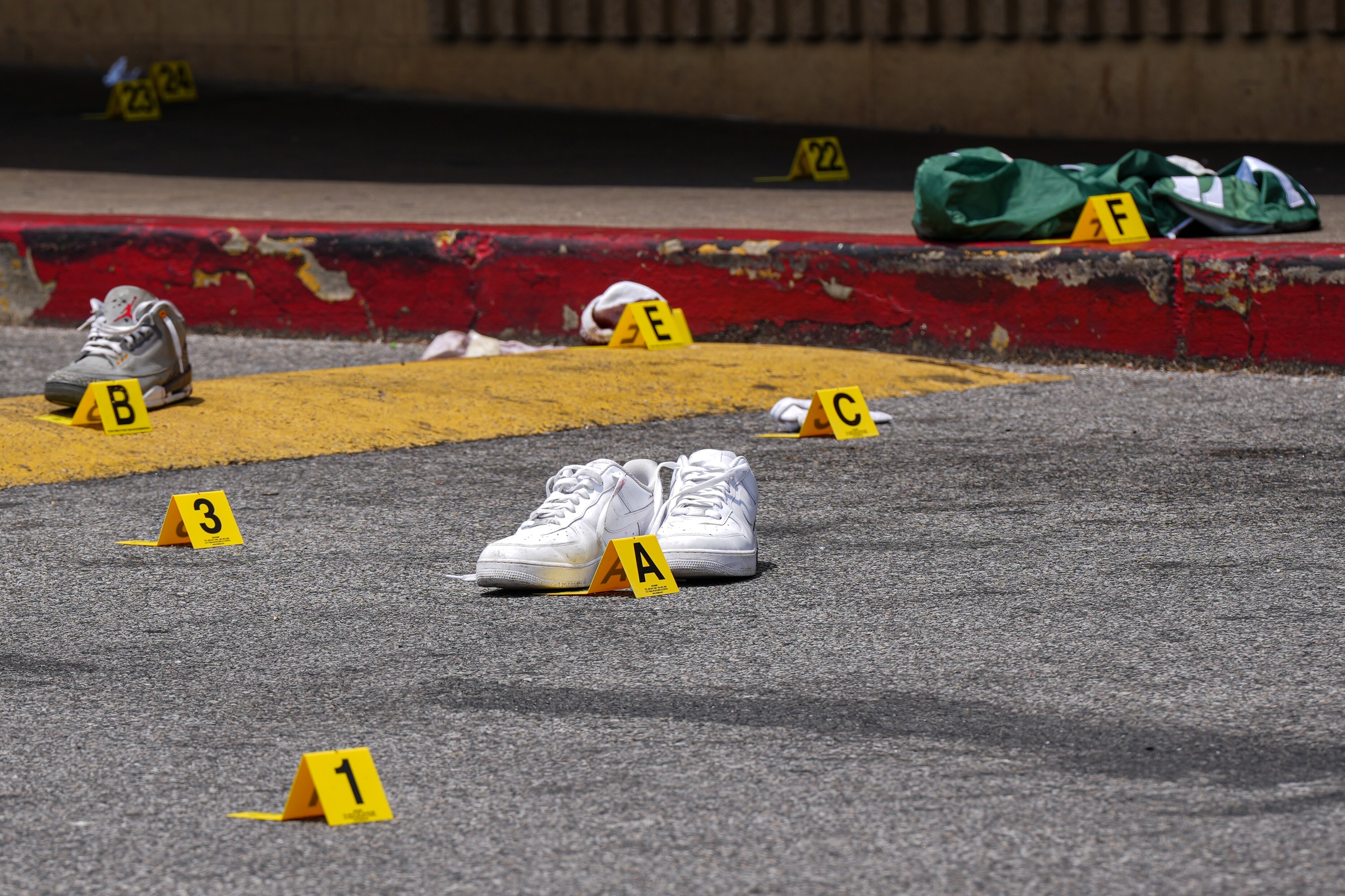 6/22/22—Police investigate a crime scene where three men were shot in a Northeast Baltimore shopping center Wednesday morning.