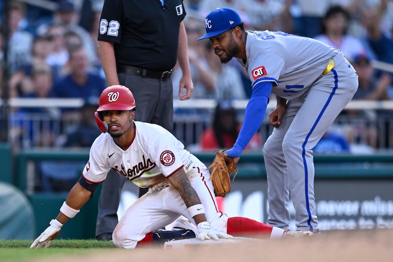 Washington Nationals' Nasim Nuñez beats the tag by Kansas City Royals third baseman Maikel Garcia for an RBI triple during the third inning.