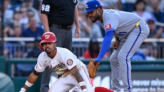 Washington Nationals' Nasim Nuñez beats the tag by Kansas City Royals third baseman Maikel Garcia for an RBI triple during the third inning.