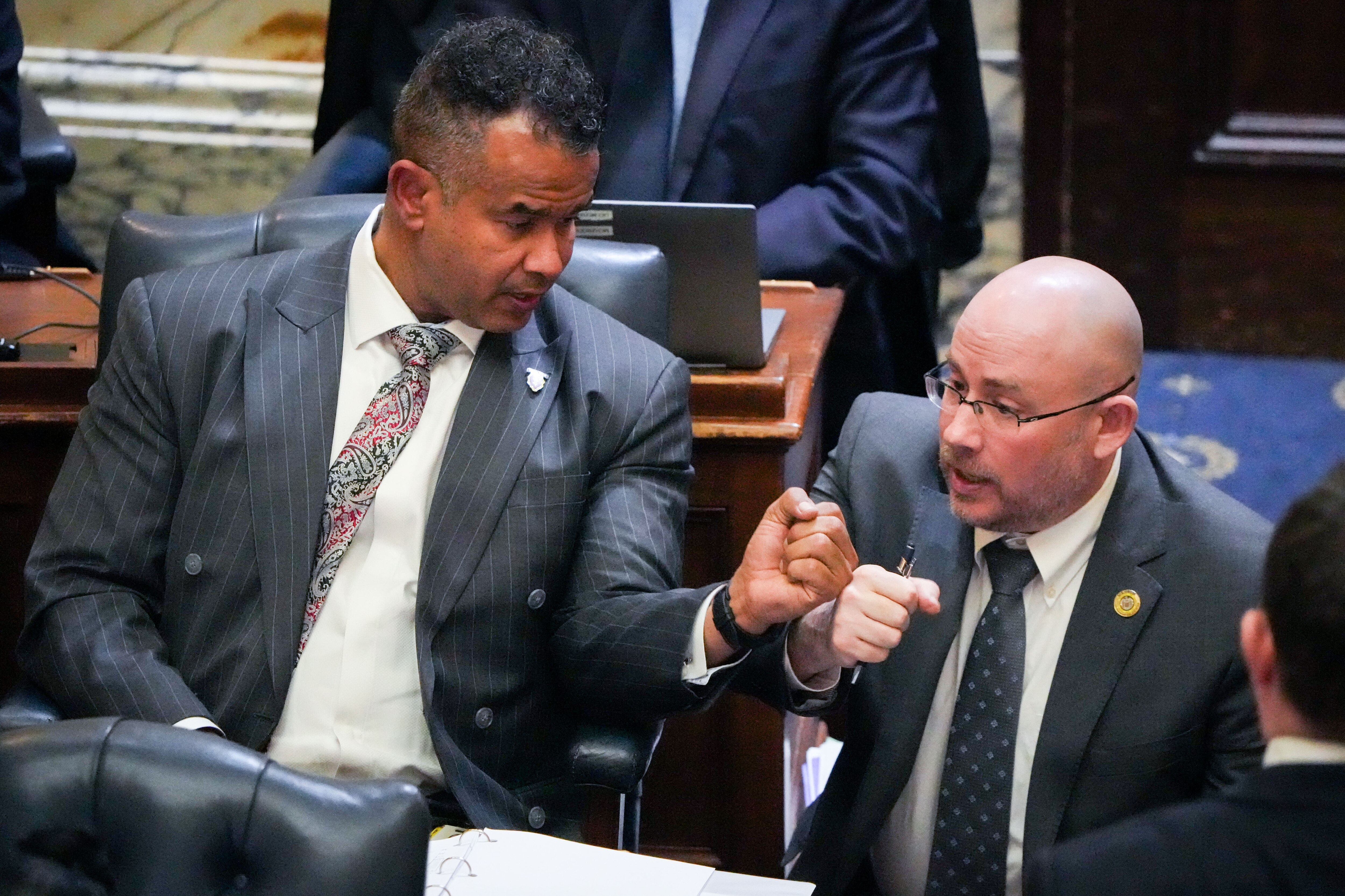 Del. C.T. Wilson (left) fist bumps Del. David Fraser-Hidalgo in the Maryland State House during sine die, the final day of the 2024 General Assembly session in Annapolis, on April 8, 2024. Any bill that doesn’t get passed by midnight on sine die is dead and lawmakers will need to address it next year.