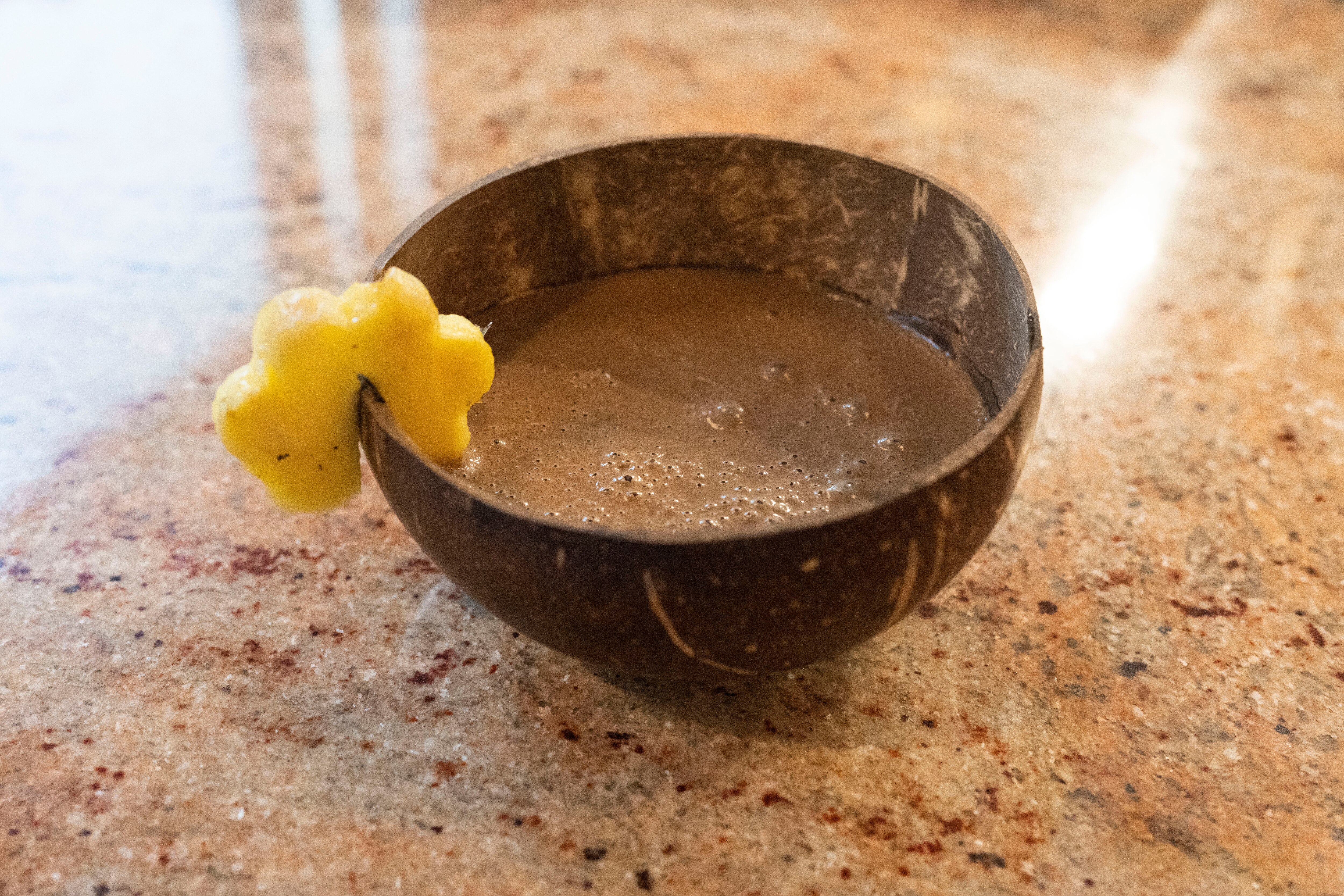 A bowl of kava garnished with a piece of pineapple at Root City Kava Bar & Lounge in Baltimore. 
