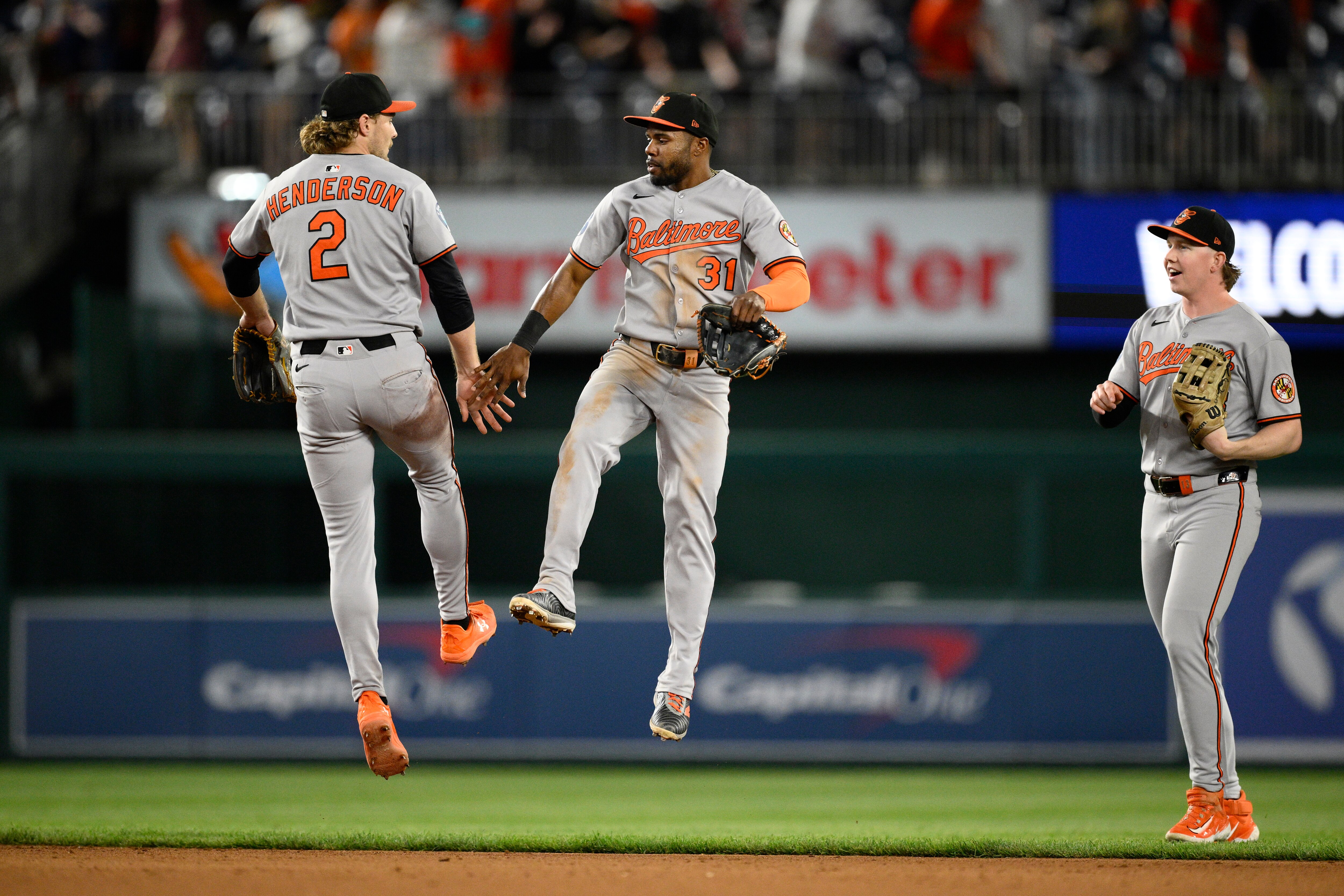 Orioles center fielder Cedric Mullins, center, makes a celebratory leap with shortstop Gunnar Henderson on Thursday night in Washington.