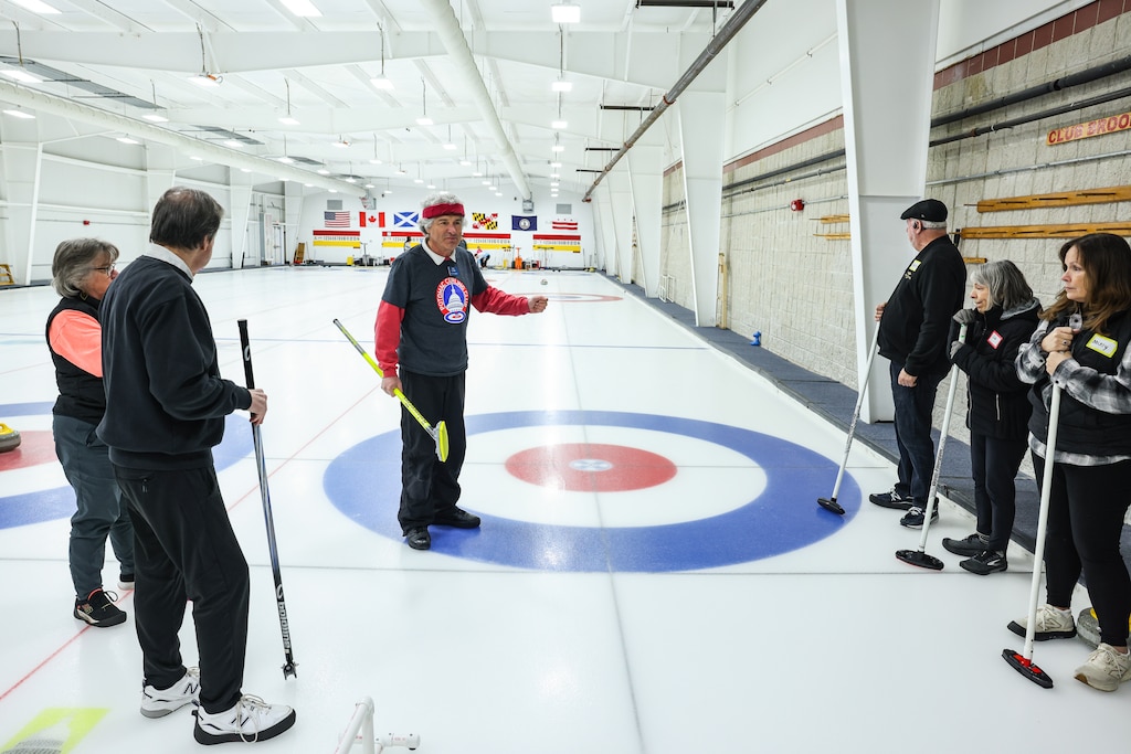 SATURDAY, FEBRUARY 21Β - Ken Clark, a member of the Potomac Curling Club, instructs first-time curlers on the basics of curling during an open house at the club in Laurel, Md. Interest in the sport has grown following the recent 2026 Winter Olympics in Cortina, Italy, drawing new participants to the Maryland club.
