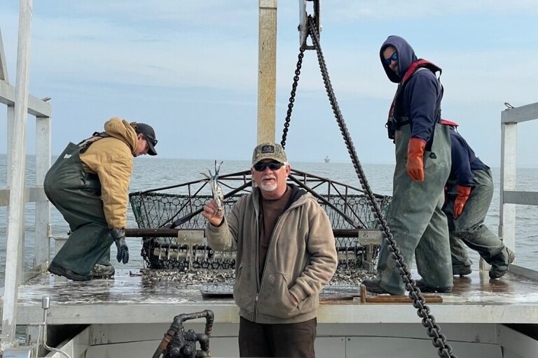 Capt. Roger Morris holds out a blue crab from the Chesapeake Bay dredged in January.
