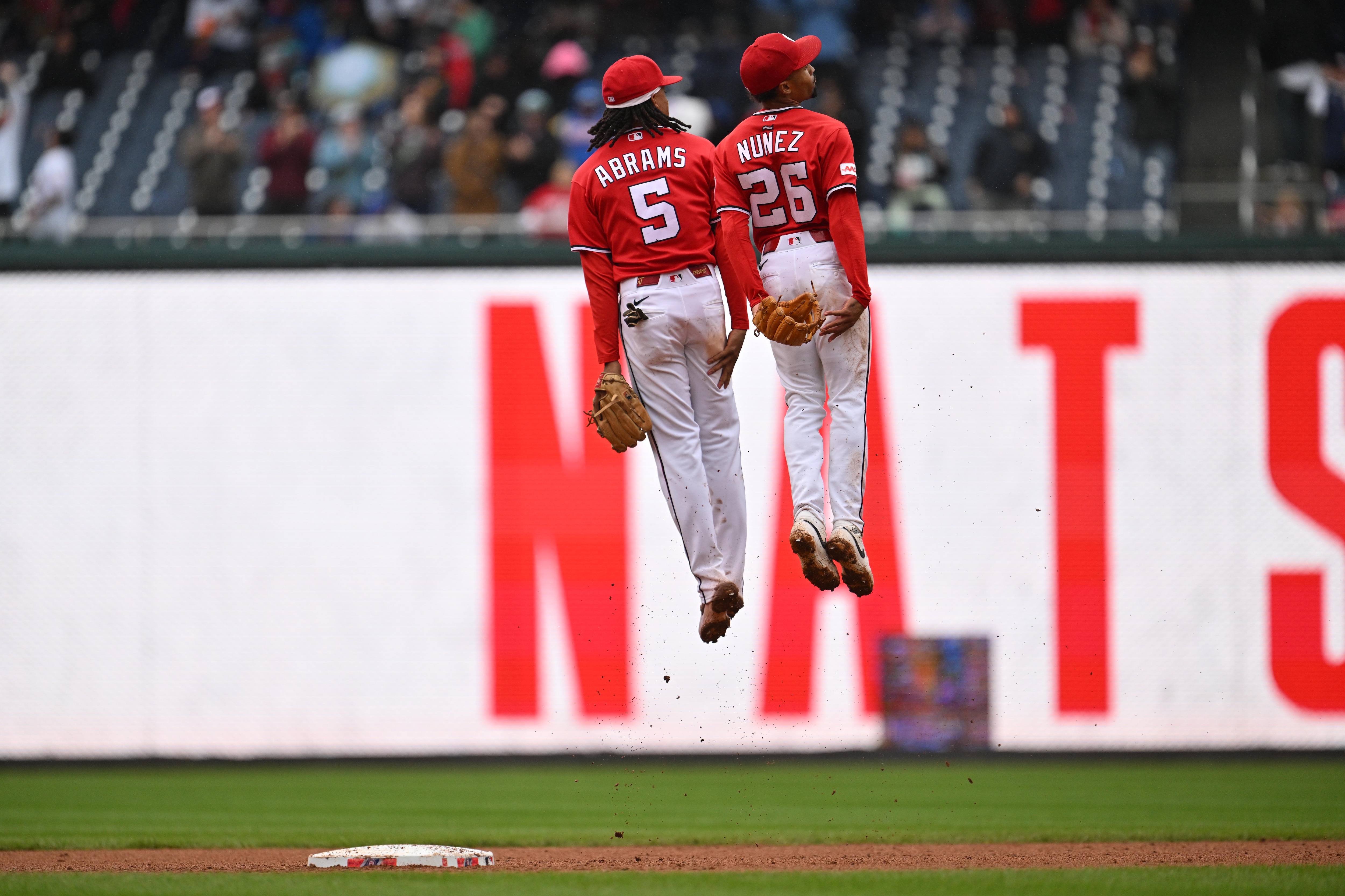 CJ Abrams and Nasim Nuñez celebrate after the Nationals defeated the New York Mets 6-4 at Nationals Park on Sunday.