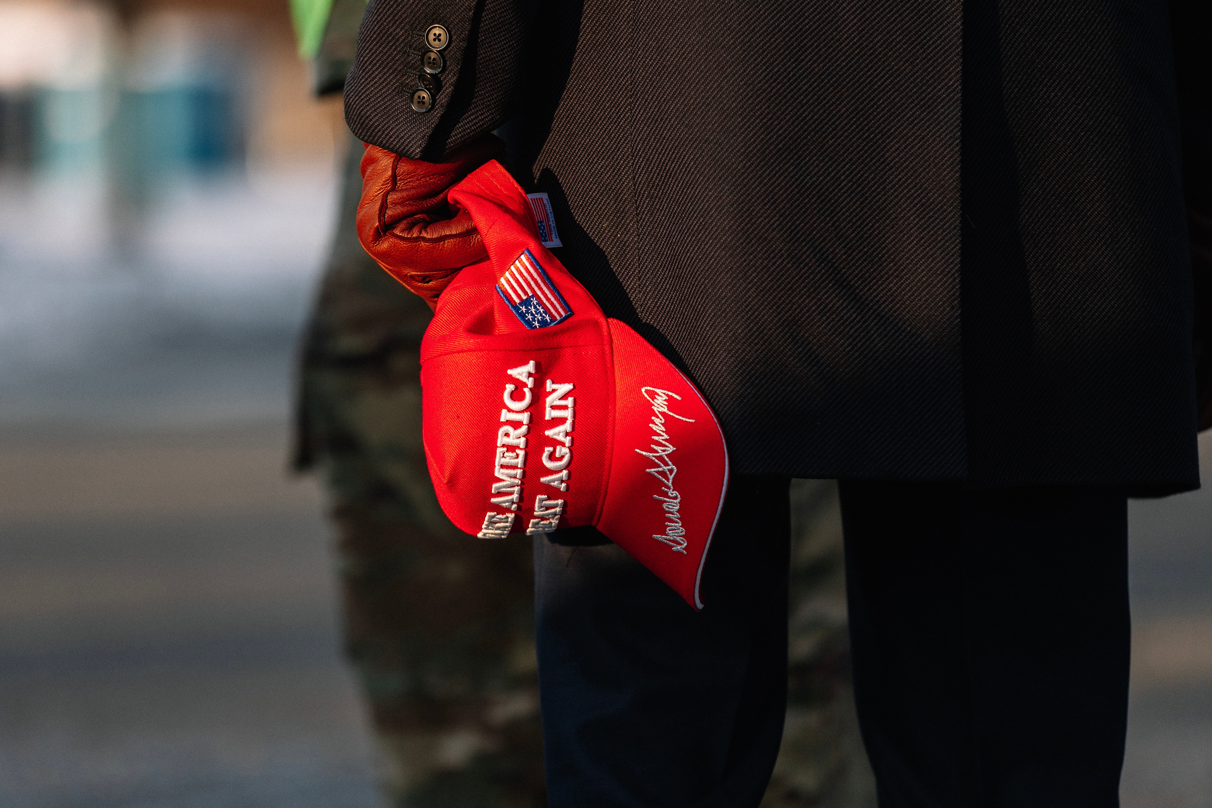 WASHINGTON, DC - JANUARY 20: A Pro-Trump supporter holding a MAGA hat stands outside of the United States Capitol before the inauguration of the 47th President of the United States of America, Donald J. Trump on January 20, 2025 in Washington, DC. Cold temperatures have forced the ceremony inside, but spectators still gather outside and around the city to celebrate.