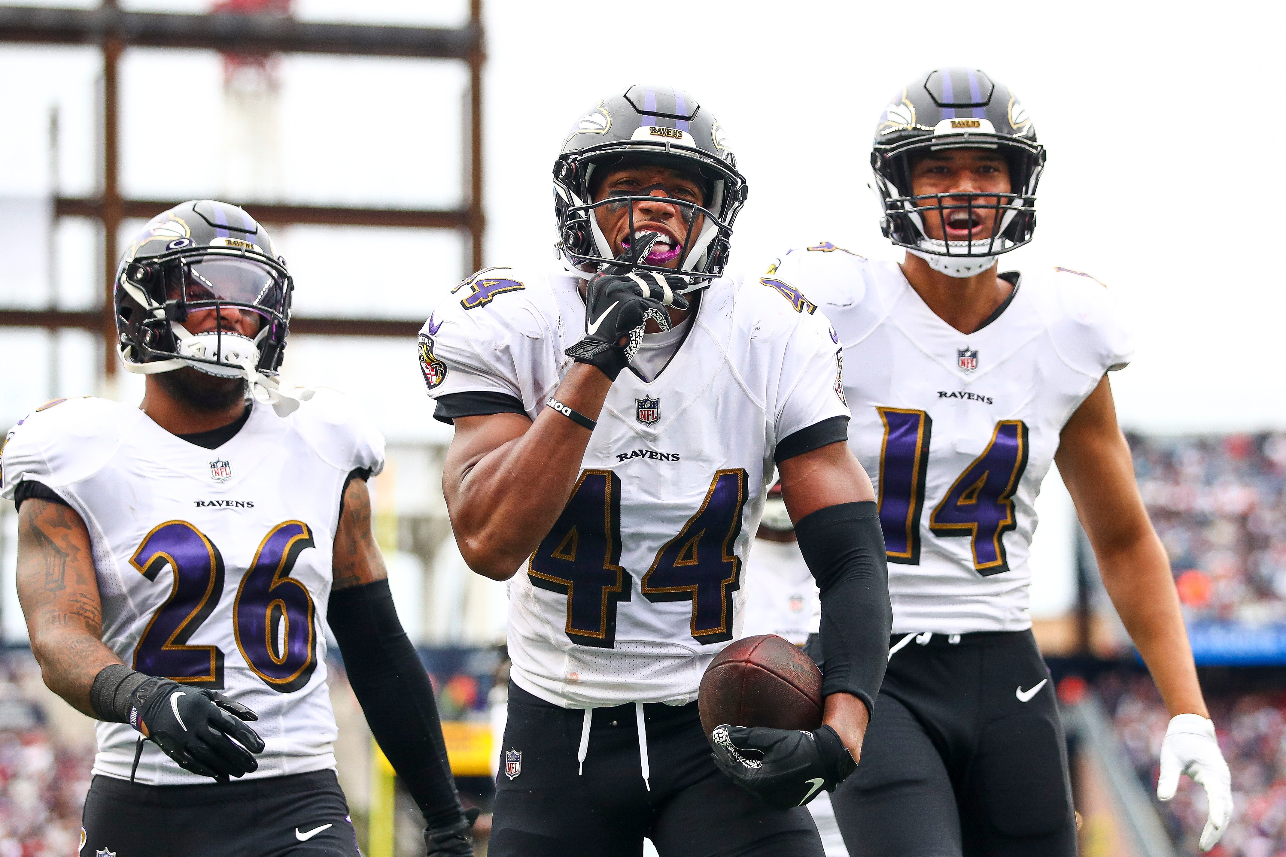 Cornerback Marlon Humphrey #44 of the Baltimore Ravens celebrates with safety Geno Stone #26 of the Baltimore Ravens and safety Kyle Hamilton #14 of the Baltimore Ravens after an interception during the fourth quarter against the New England Patriots at Gillette Stadium on September 25, 2022 in Foxborough, Massachusetts.