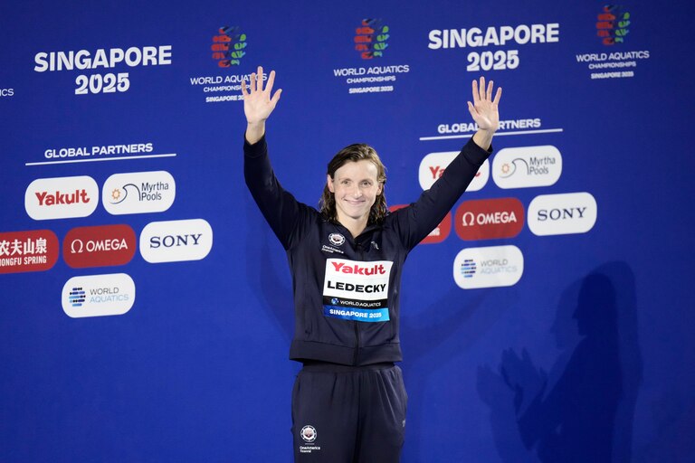 Gold medalist Katie Ledecky of the United States celebrates on the podium after the women's 800-meter freestyle final at the World Aquatics Championships in Singapore, Saturday, Aug. 2, 2025. (AP Photo/Lee Jin-man)