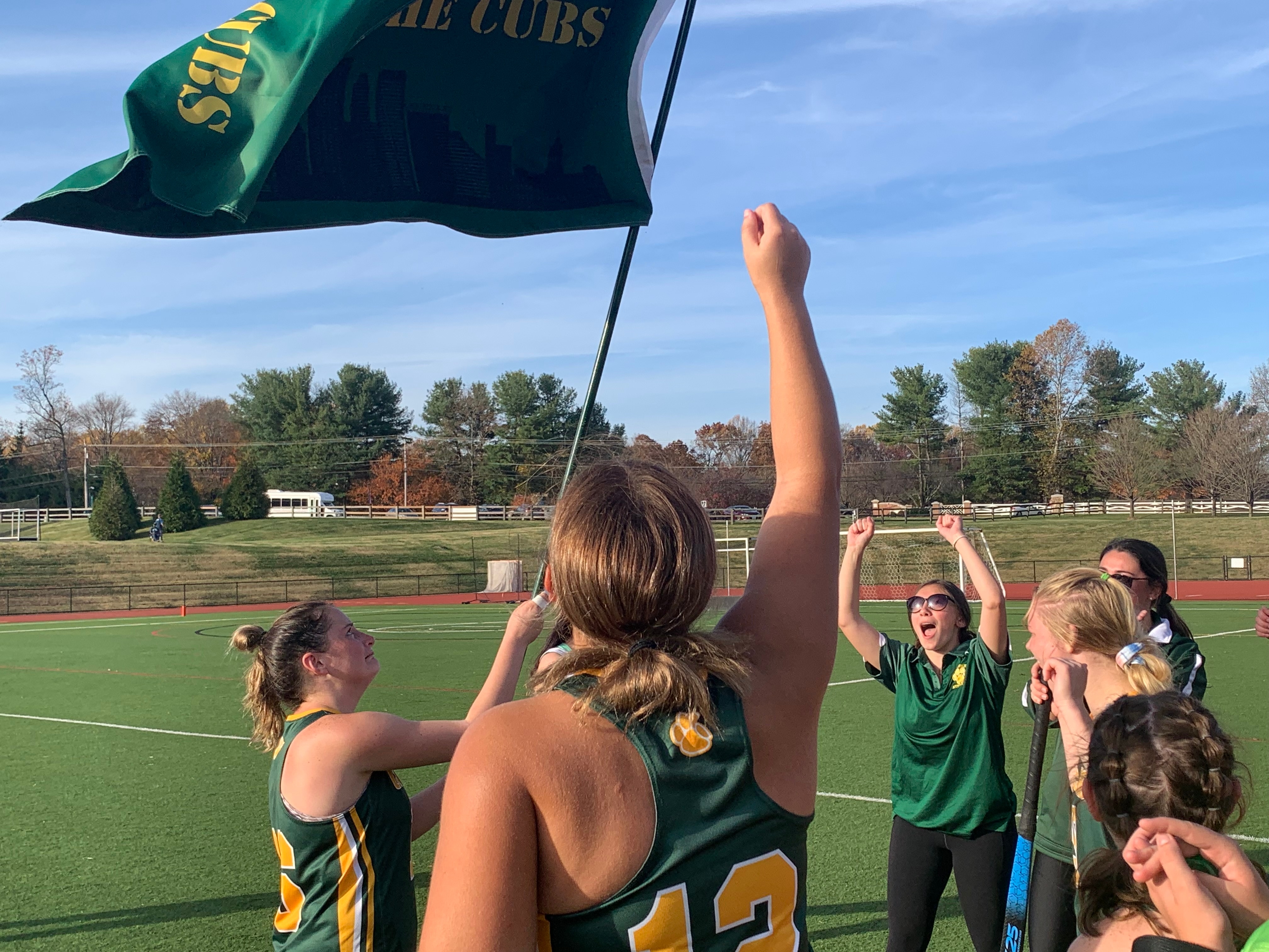 Catholic's Rachel Roane waves the school flag after Friday's IAAM C Conference field hockey championship game. The Cubs won their first title since 2013 with a 3-1 victory over Annapolis Area Christian at Glenelg Country School.