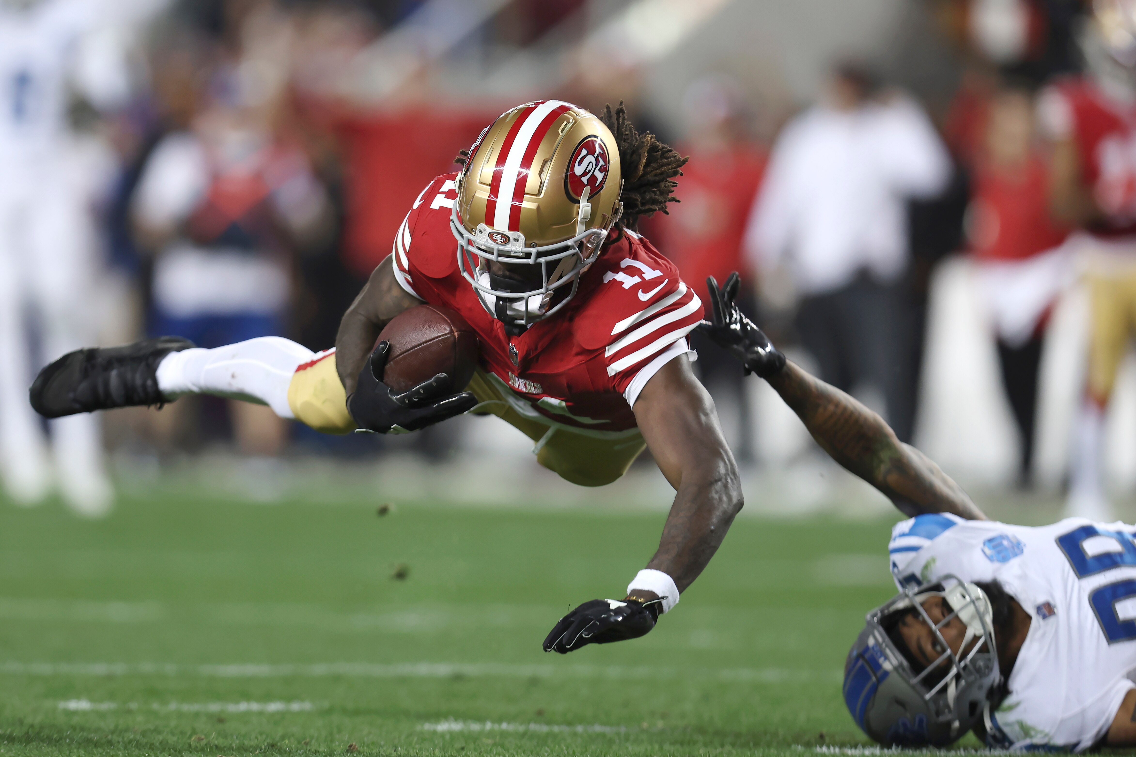 49ers wide receiver Brandon Aiyuk catches a pass against Lions cornerback Kindle Vildor during the second half of the NFC championship game.