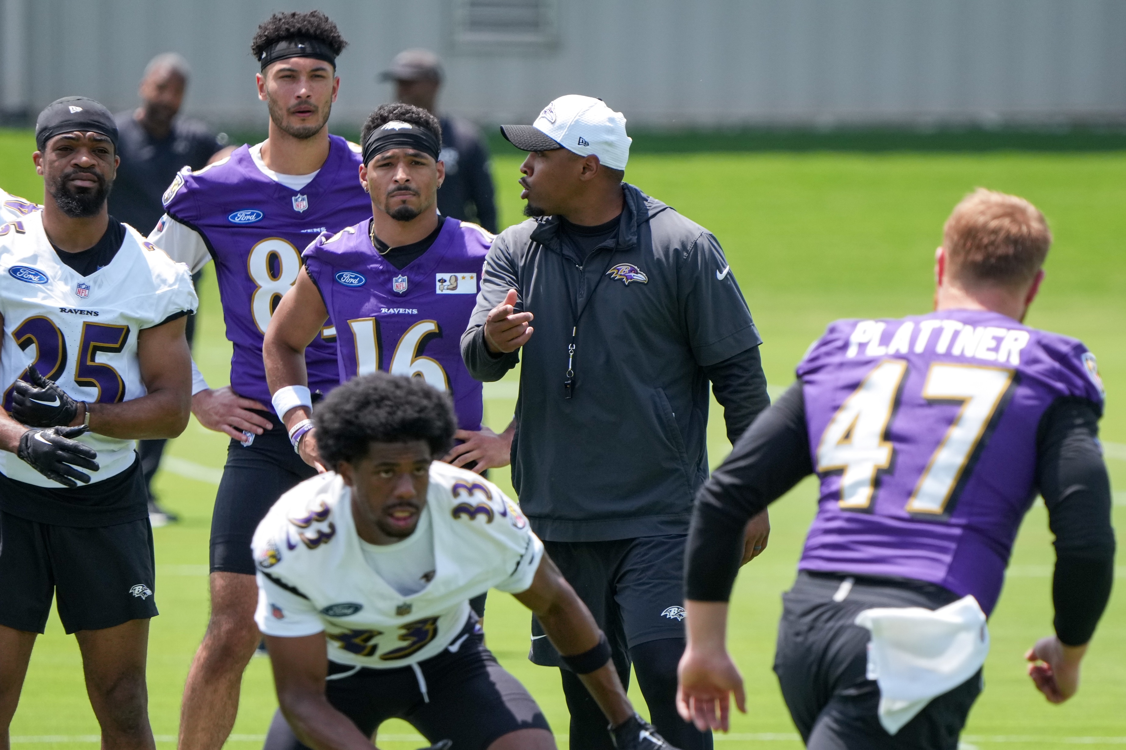 Special Teams Coordinator Chris Horton gives instructions to players running drills during the Baltimore Ravens’ organized team activities at the Under Armour Performance Center in Owings Mills on June 4, 2024.