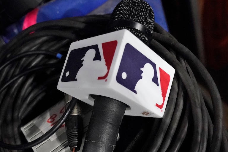A microphone belonging to a field reporter for the San Diego Padres sits on top of audio cables during a baseball game between the Miami Marlins and the Padres, May 31, 2023, in Miami. (AP Photo/Wilfredo Lee, File)