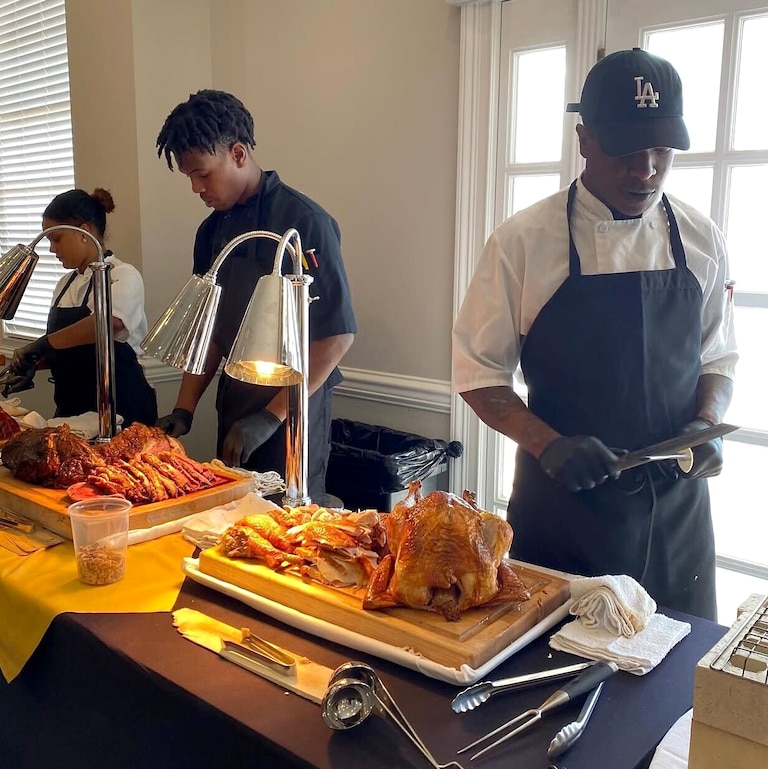 Alex Claro, right, at a turkey carving station.