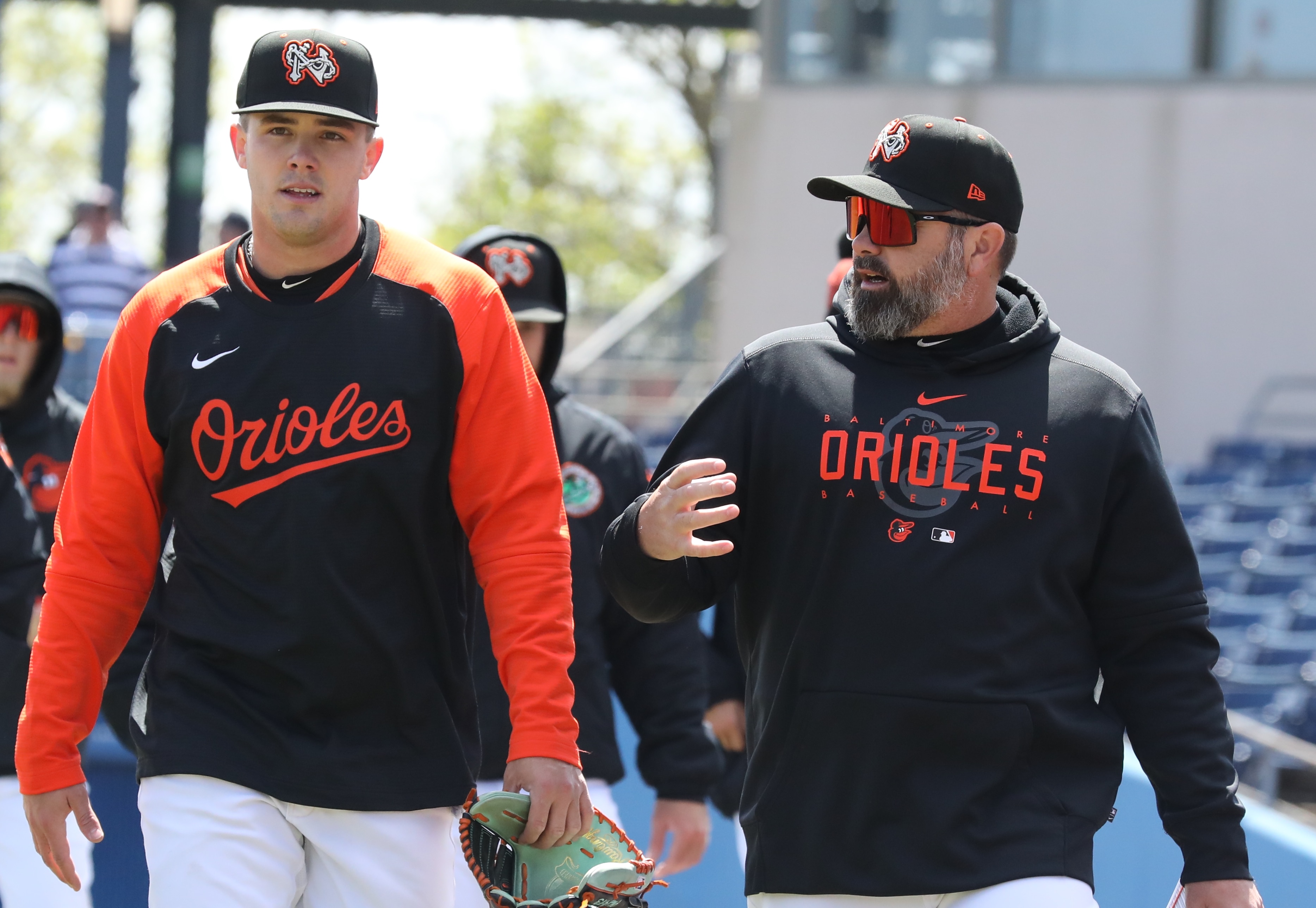 Norfolk Tides pitching coach Justin Ramsey, right, speaks to TK TK.