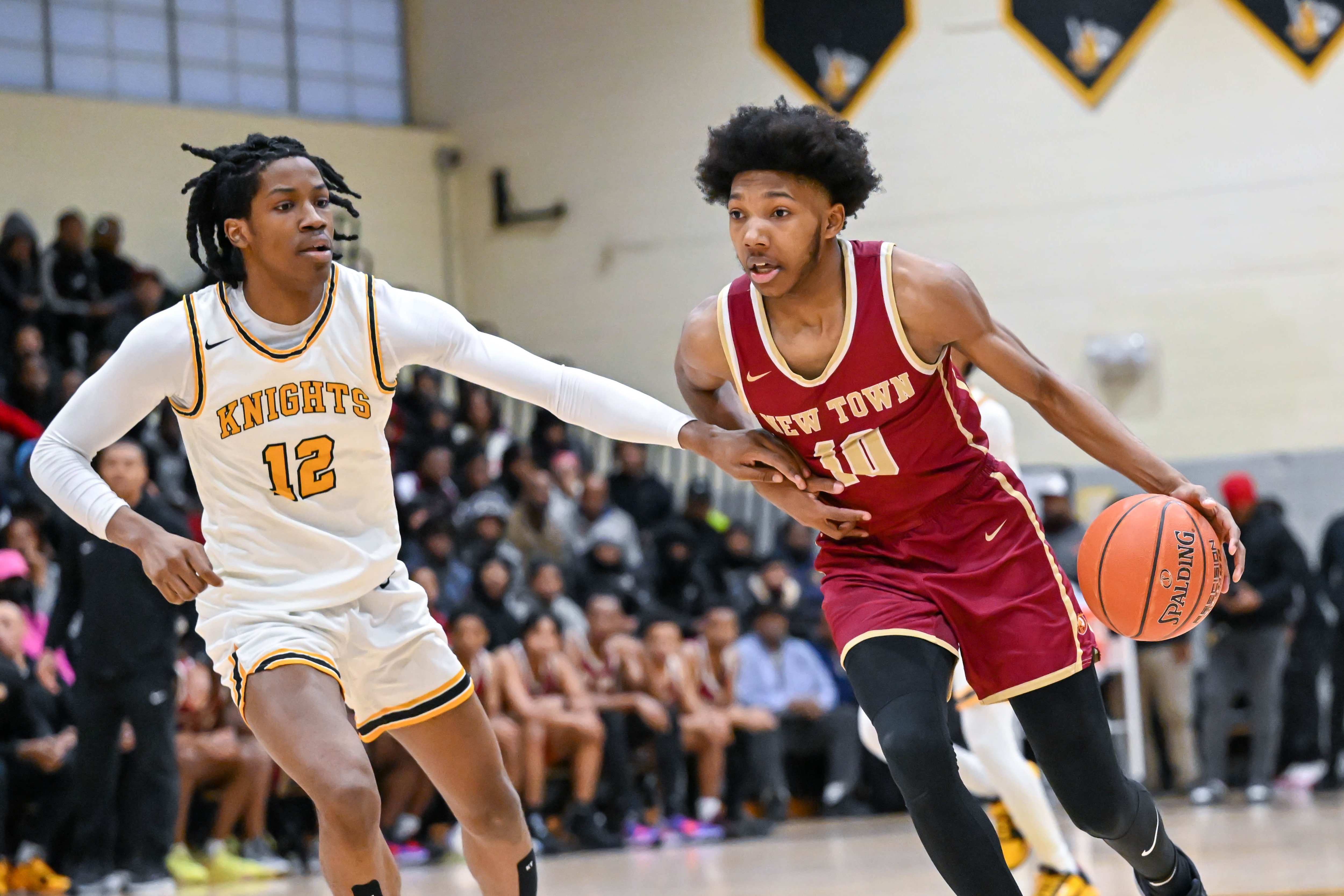 New Town's Camaren Sparrow (10) works against the defense of Parkville's Caron Smith (12).
