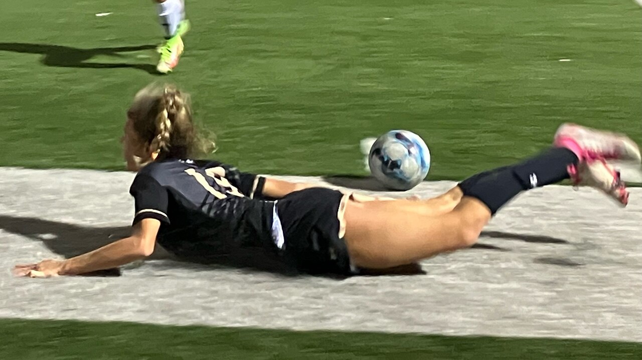John Carroll senior Elise Robinson takes a spill as her top-ranked Patriots tangled in an all-out showdown with No. 6 NDP, Wednesday night. The contest ended in a 1-1 tie.