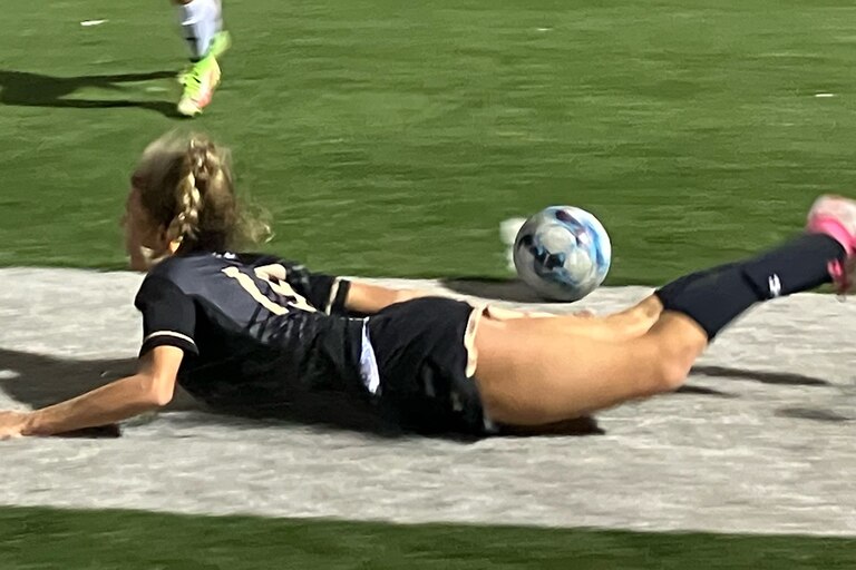 John Carroll senior Elise Robinson takes a spill as her top-ranked Patriots tangled in an all-out showdown with No. 6 NDP, Wednesday night. The contest ended in a 1-1 tie.