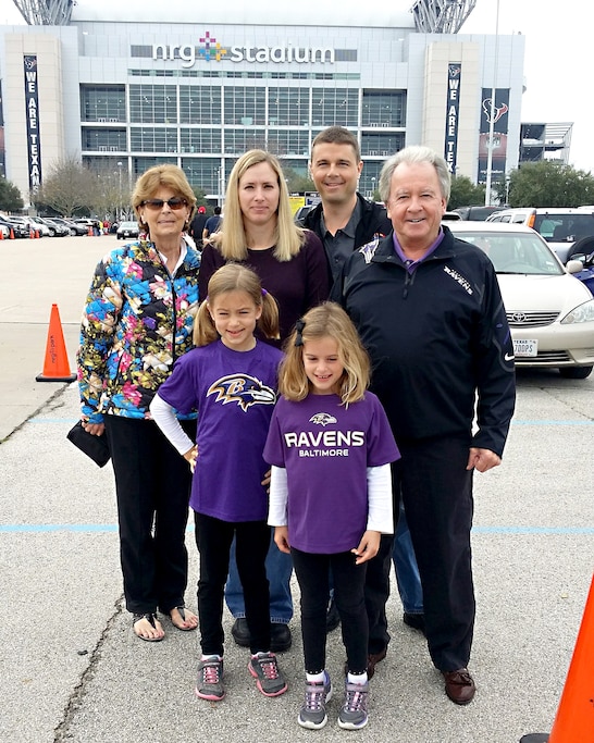 Astronaut Reid Wiseman poses with his parents, wife and children outside Houston's NRG Stadium.