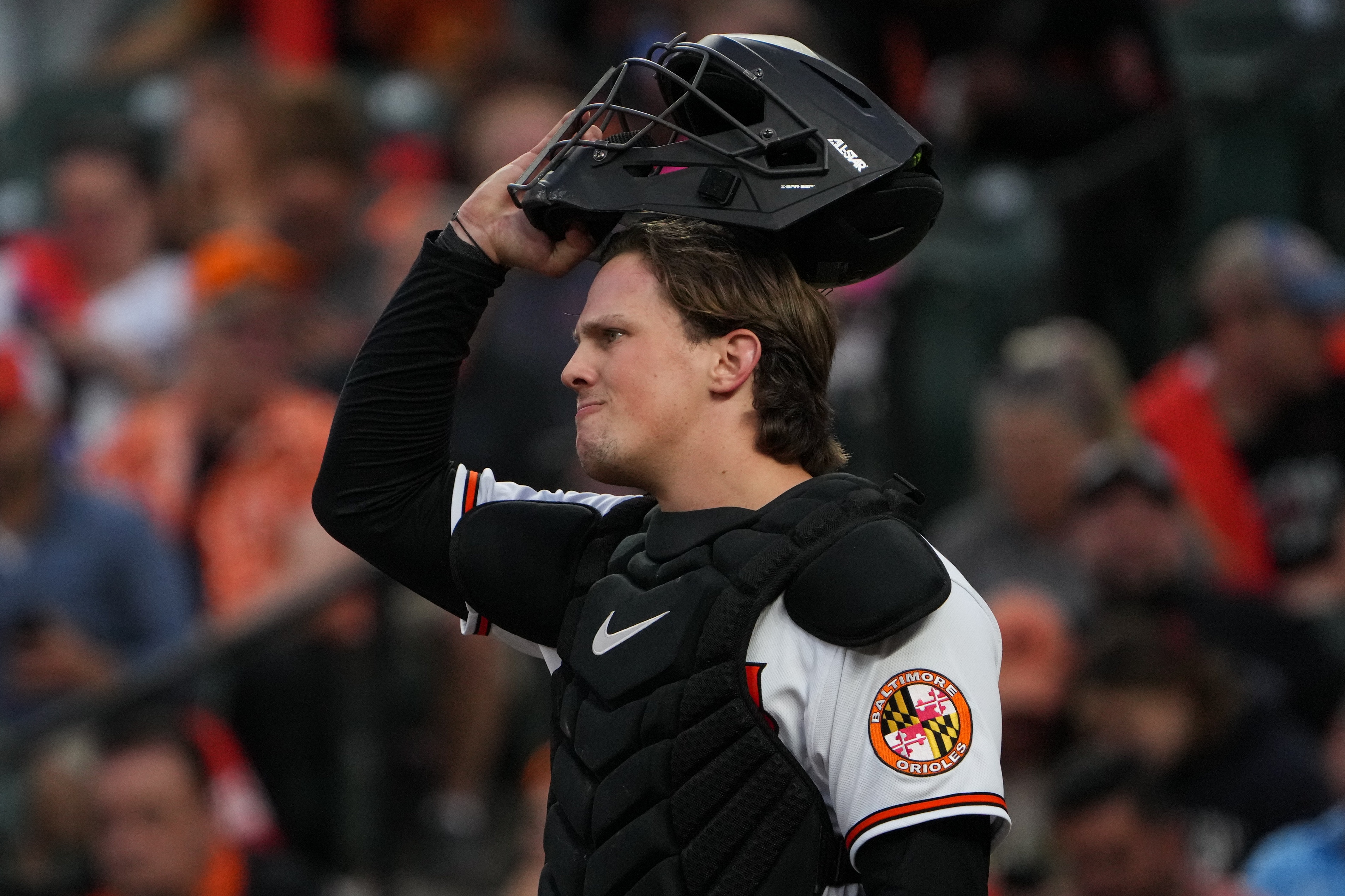 Baltimore Orioles catcher Adley Rutschman (35) puts his helmet on after a meeting on the mound in a baseball game against the Oakland Athletics at Camden Yards on Tuesday, April 11. The Orioles beat the Athletics, 12-8, in the second game of the series.