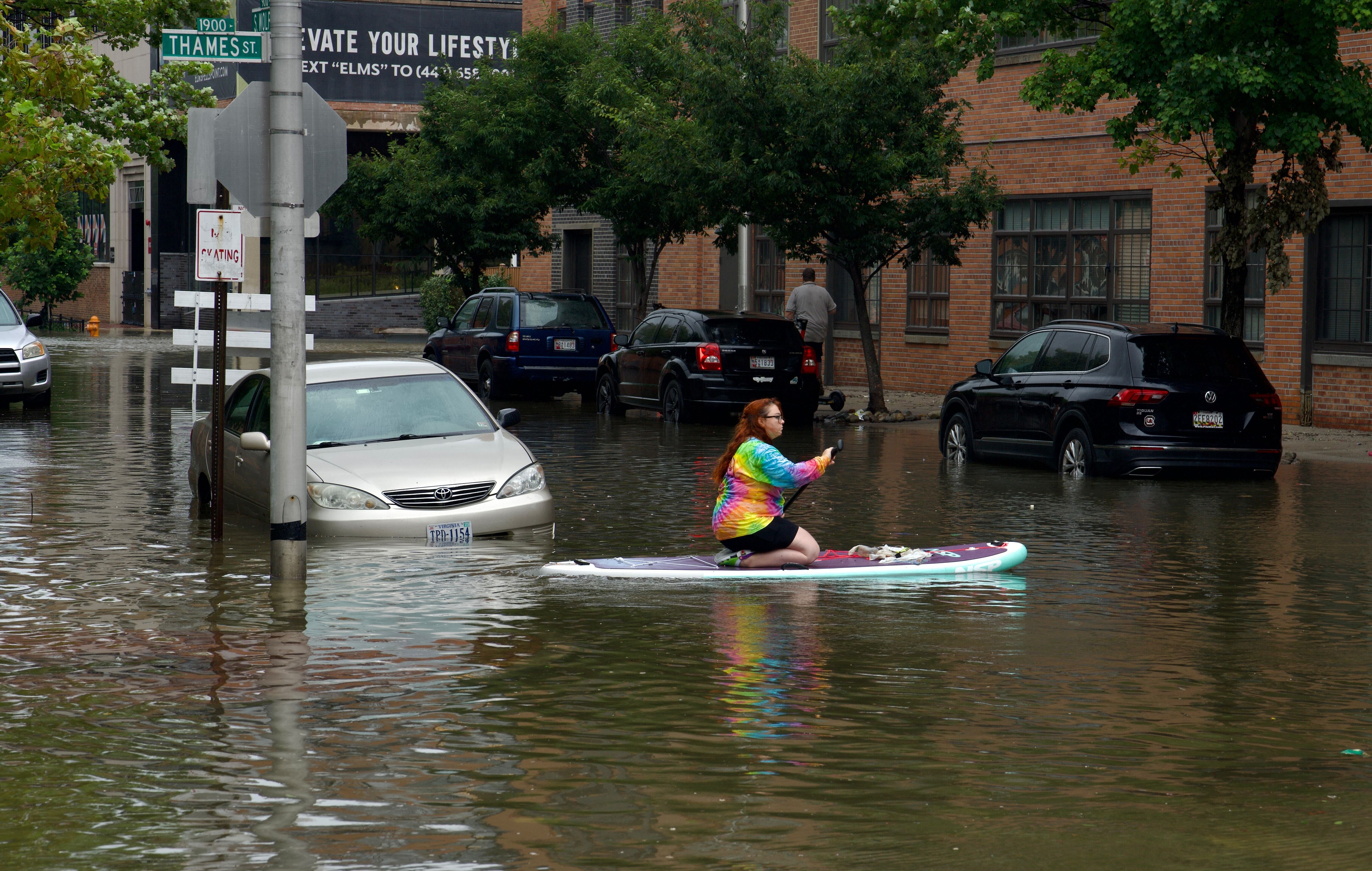 Lily Gensler goes for a paddle in Fells Point as the remnants of Hurricane Debby pass through Maryland.