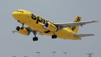 A Spirit airlines plane takes off from Miami International Airport on July 27, 2022 in Miami, Florida. Spirit Airlines Inc. shareholders are voting whether to merge with Frontier Airlines or JetBlue Airways Corp.