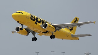 A Spirit airlines plane takes off from Miami International Airport on July 27, 2022 in Miami, Florida. Spirit Airlines Inc. shareholders are voting whether to merge with Frontier Airlines or JetBlue Airways Corp.