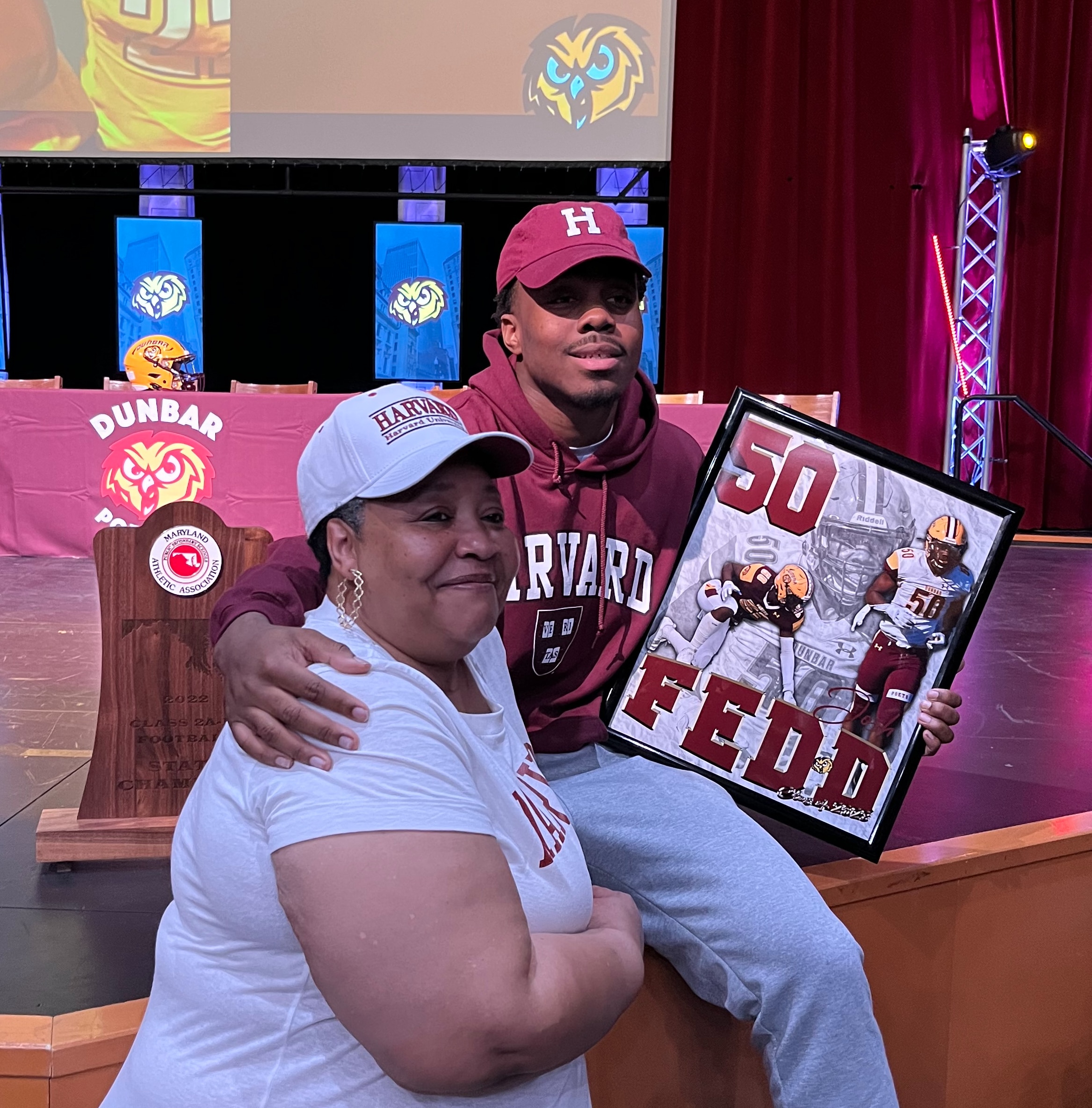 Dunbar's Josh Fedd poses for a picture with grandmother Susan Knight after Wednesday's signing ceremony inside Dunbar's auditorium. Fedd, a standout two-way linemen for the back-to-back Class 2A/1A state champion Poets, will be attending Harvard University in the fall.