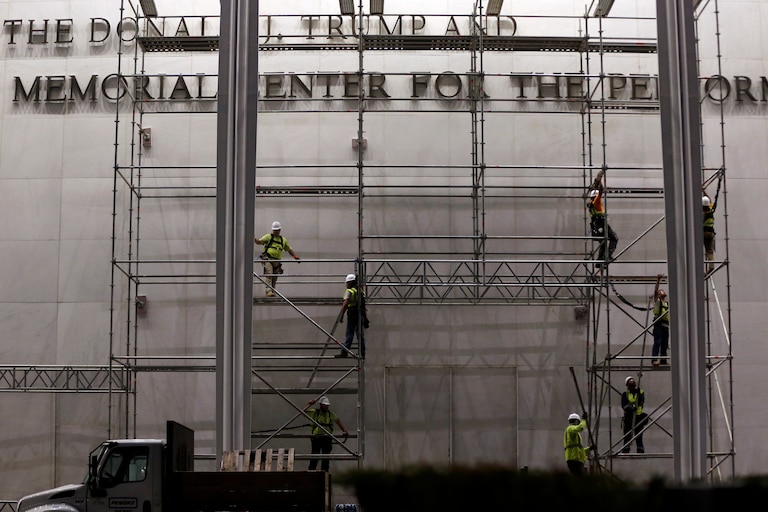 Workers construct scaffolding below the sign for the John F. Kennedy Center for the Performing Arts, Friday, June 12, 2026, in Washington. (AP Photo/Rahmat Gul)