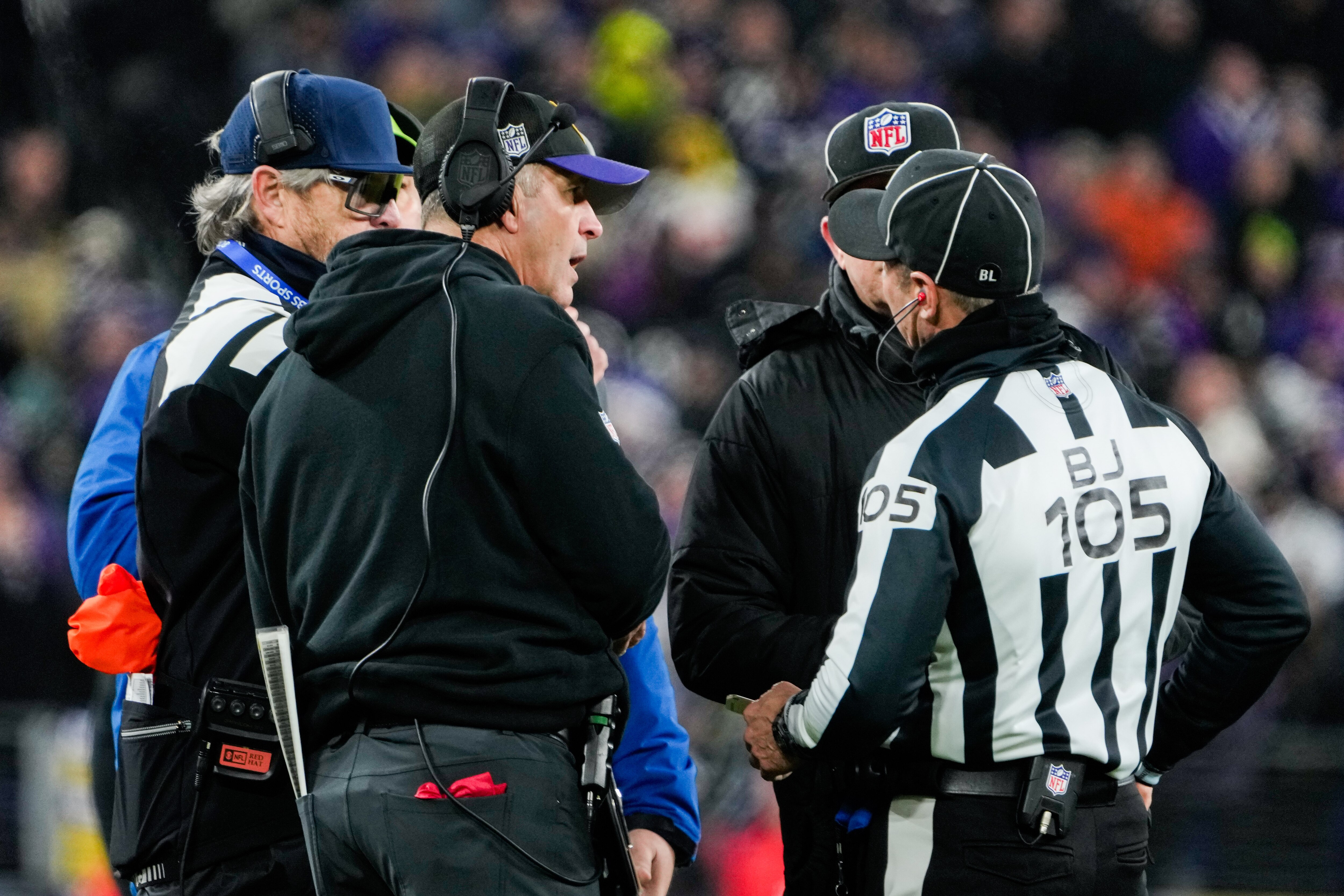 Ravens coach John Harbaugh talks with referees during the fourth quarter of the AFC championship game Sunday.