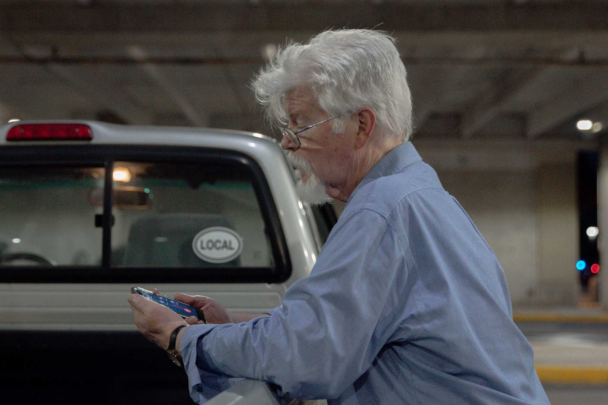 Reporter Pat Furgurson works his phone in the hours after five of his colleagues were murdered in their Annapolis newsroom on June 28, 2018.