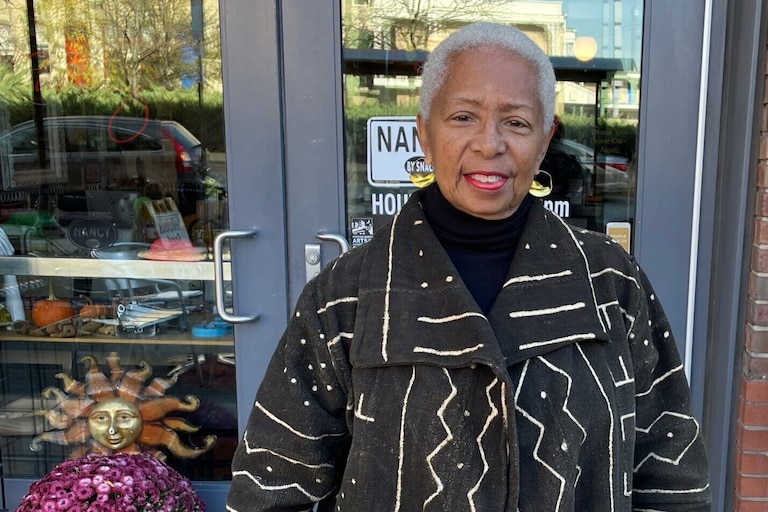 Wanda Watts stands in front of a restaurant in Baltimore.