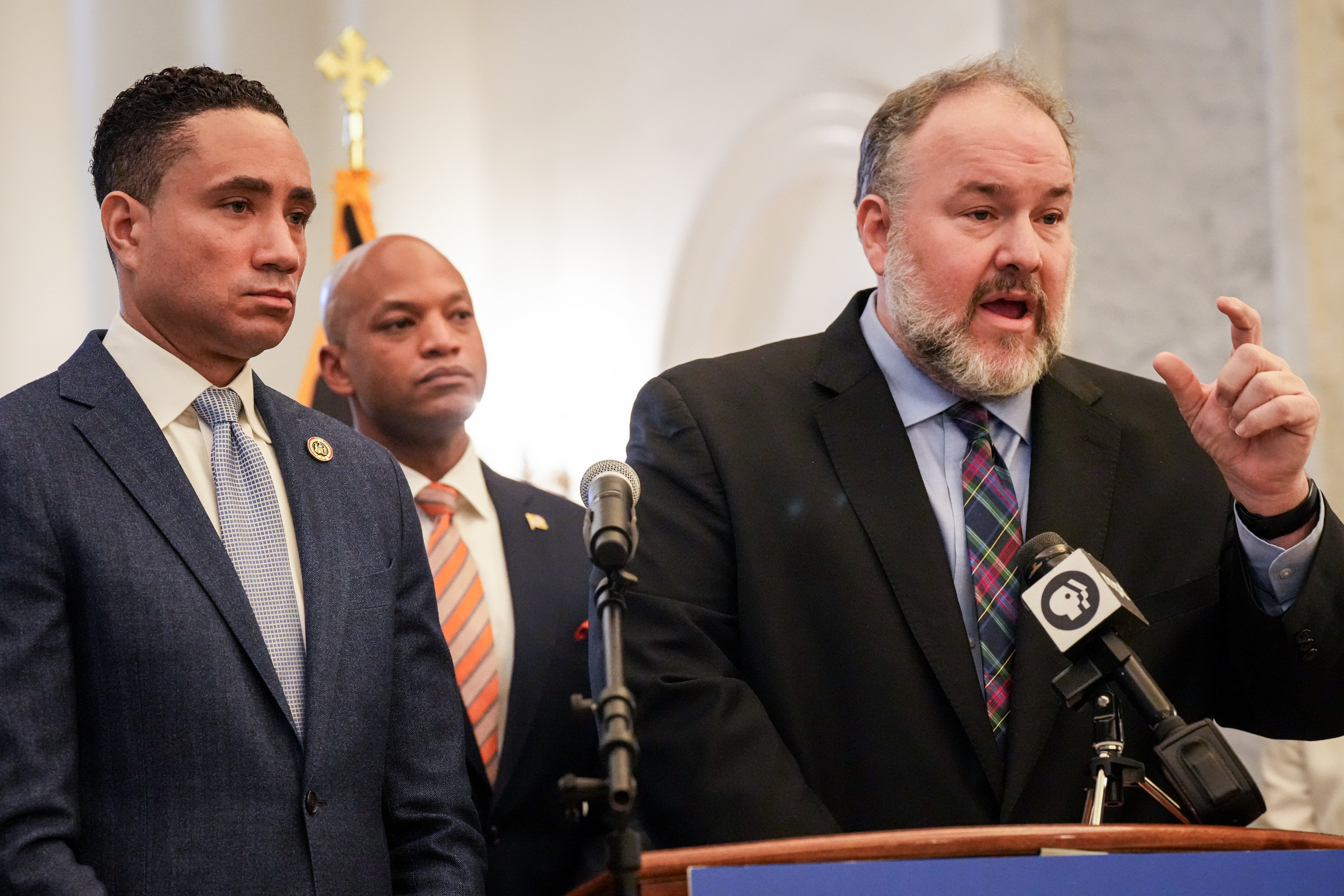 Del. Luke Clippinger, chairman of the House Judiciary Committee, right, announces new juvenile justice legislation in the Maryland State House lobby. Beside him are Sen. Will Smith, chairman of the Senate Judicial Proceedings Committee, at far left, and Gov. Wes Moore, center.