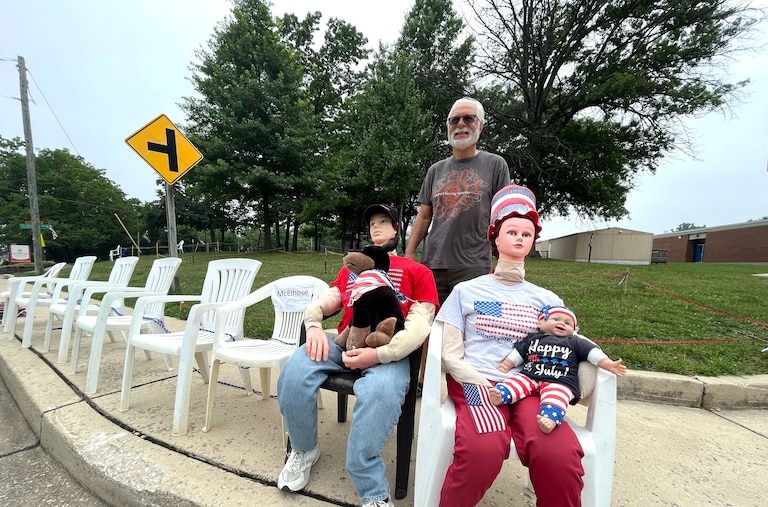 Ed Fitzpatrick stands with mannequins that he and his wife, Holly Fitzpatrick, set out each Independence Day to reserve space on the Frederick Road parade route and to show their holiday spirit.