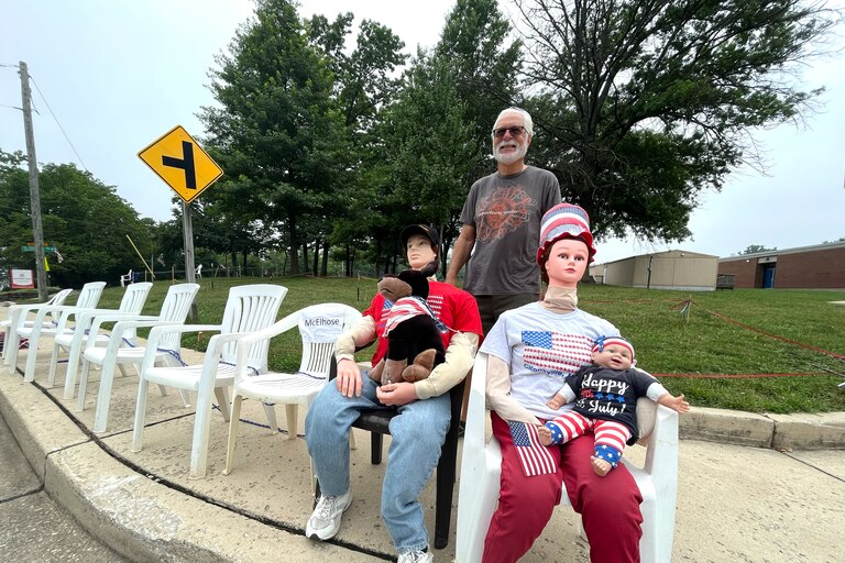 Ed Fitzpatrick stands with mannequins that he and his wife, Holly Fitzpatrick, set out each Independence Day to reserve space on the Frederick Road parade route and to show their holiday spirit.